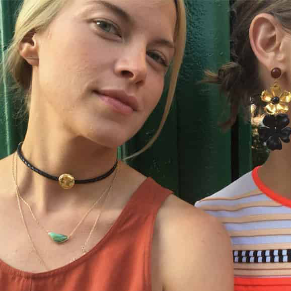 Kate Towill, blonde woman wears orange tank with dainty necklaces