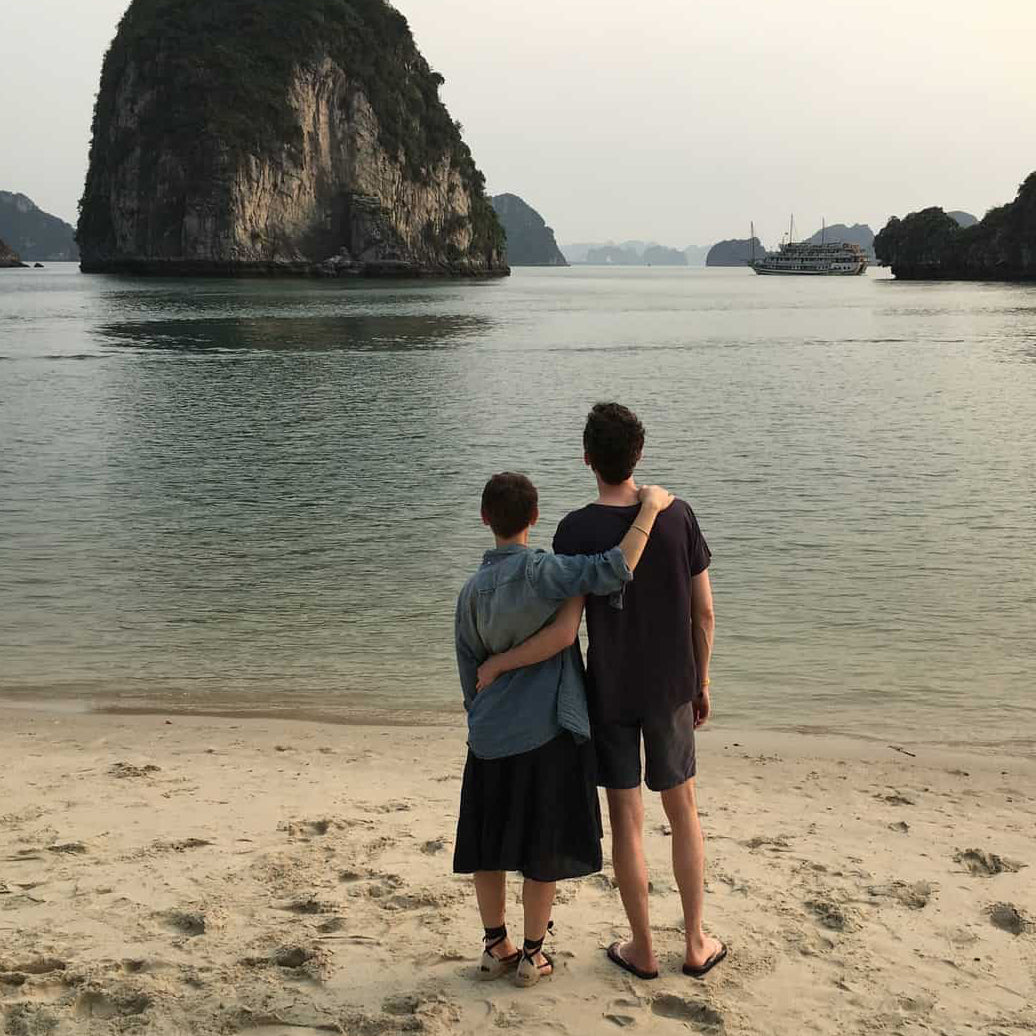 Lizzie and Peter looking out onto ocean and large rocks