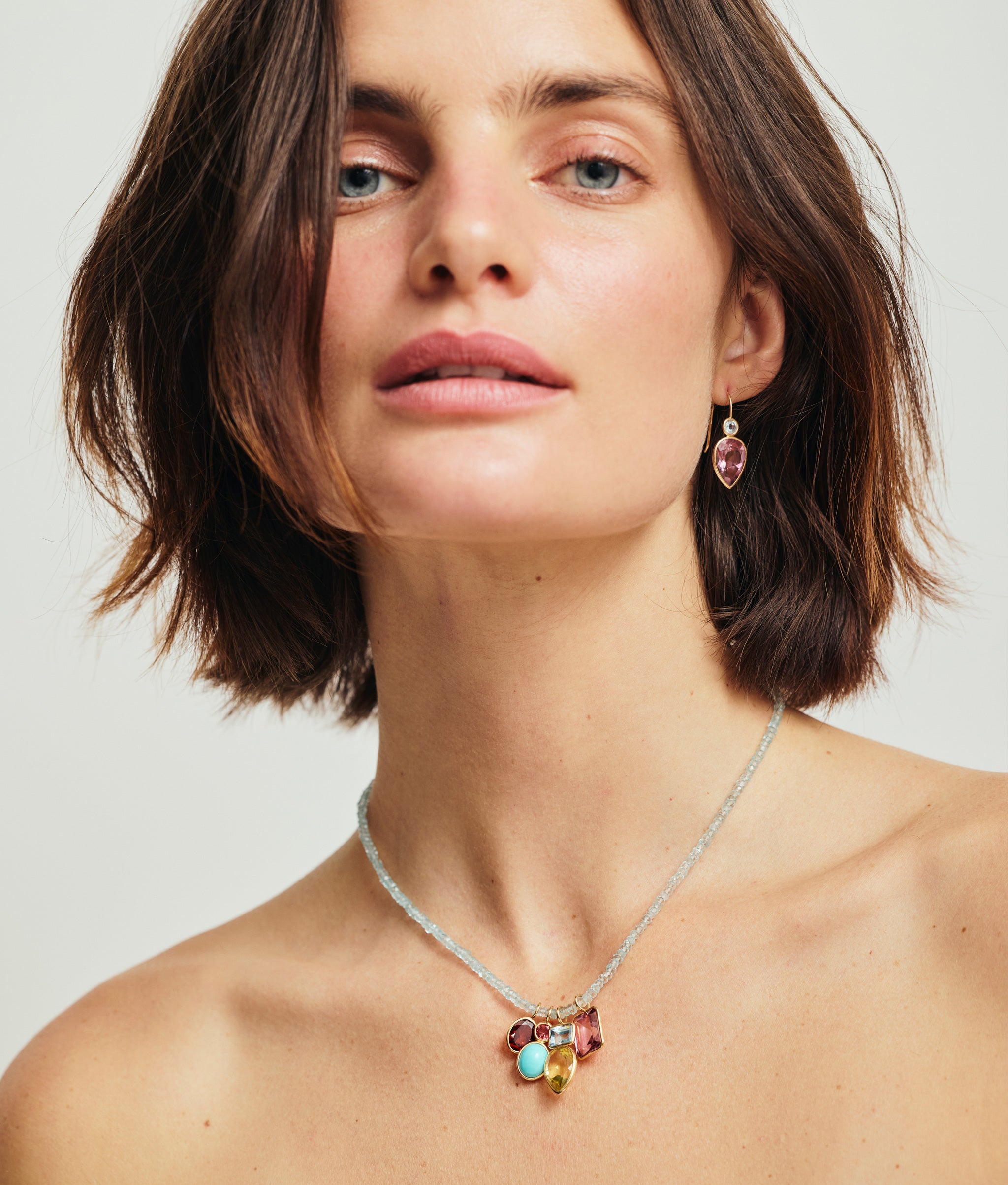 Model wears Fine Mood Charm Necklace in Aquamarine Oasis and Hera Earrings in Pink Topaz.