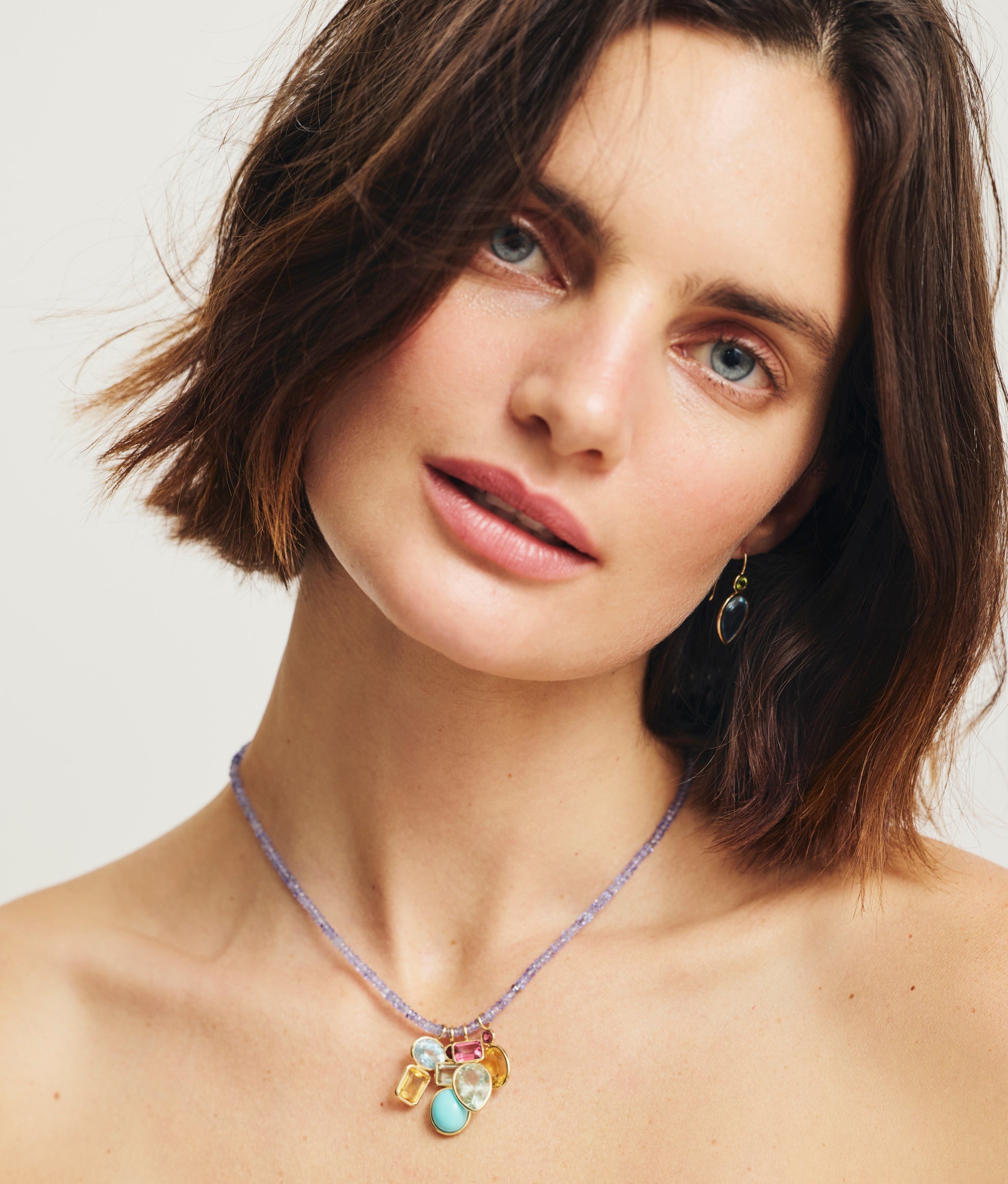 Model wears Fine Mood Charm Necklace in Tanzanite Treasure.