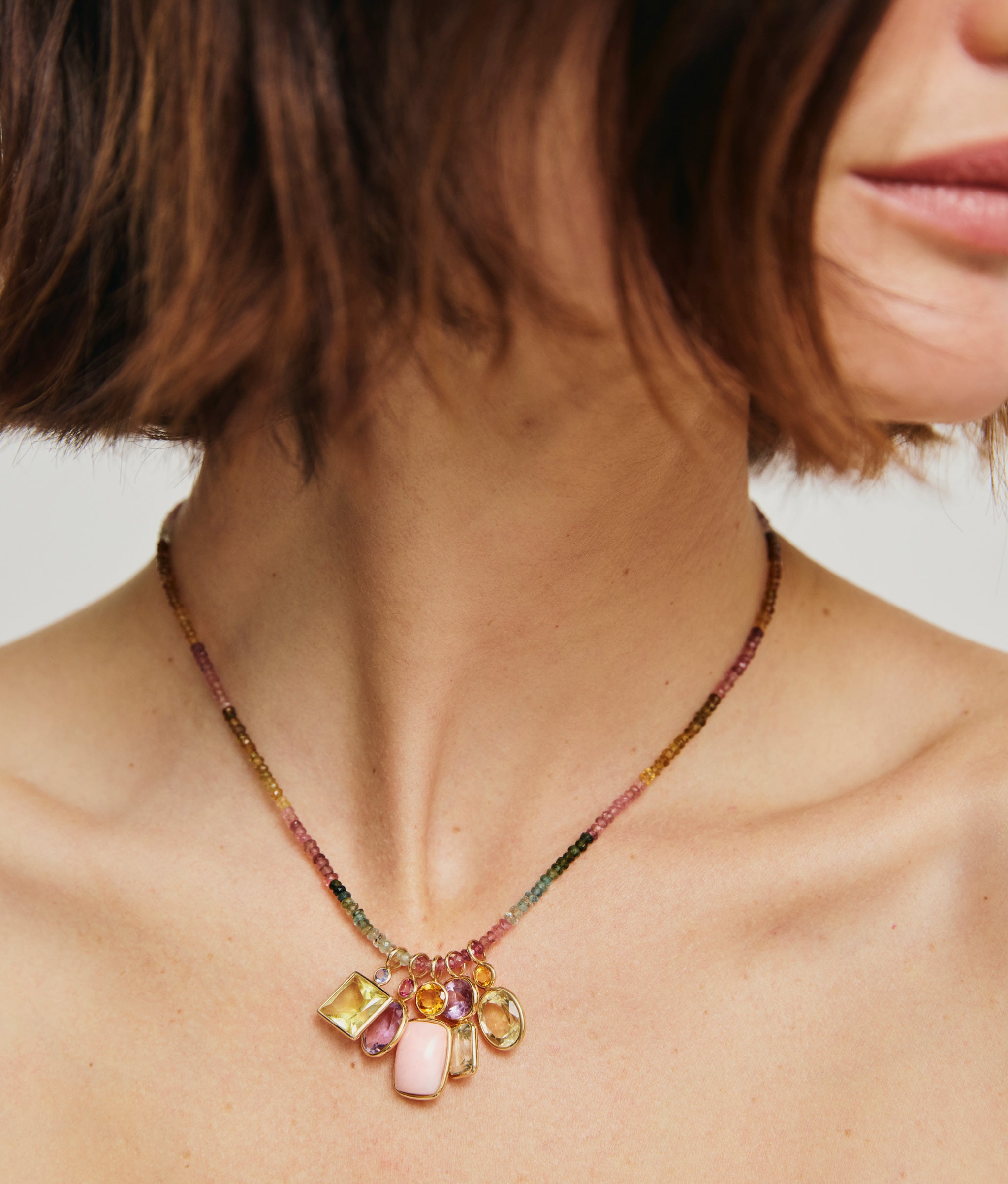 Close-up on model wearing Fine Mood Charm Necklace in Tourmaline Dream.