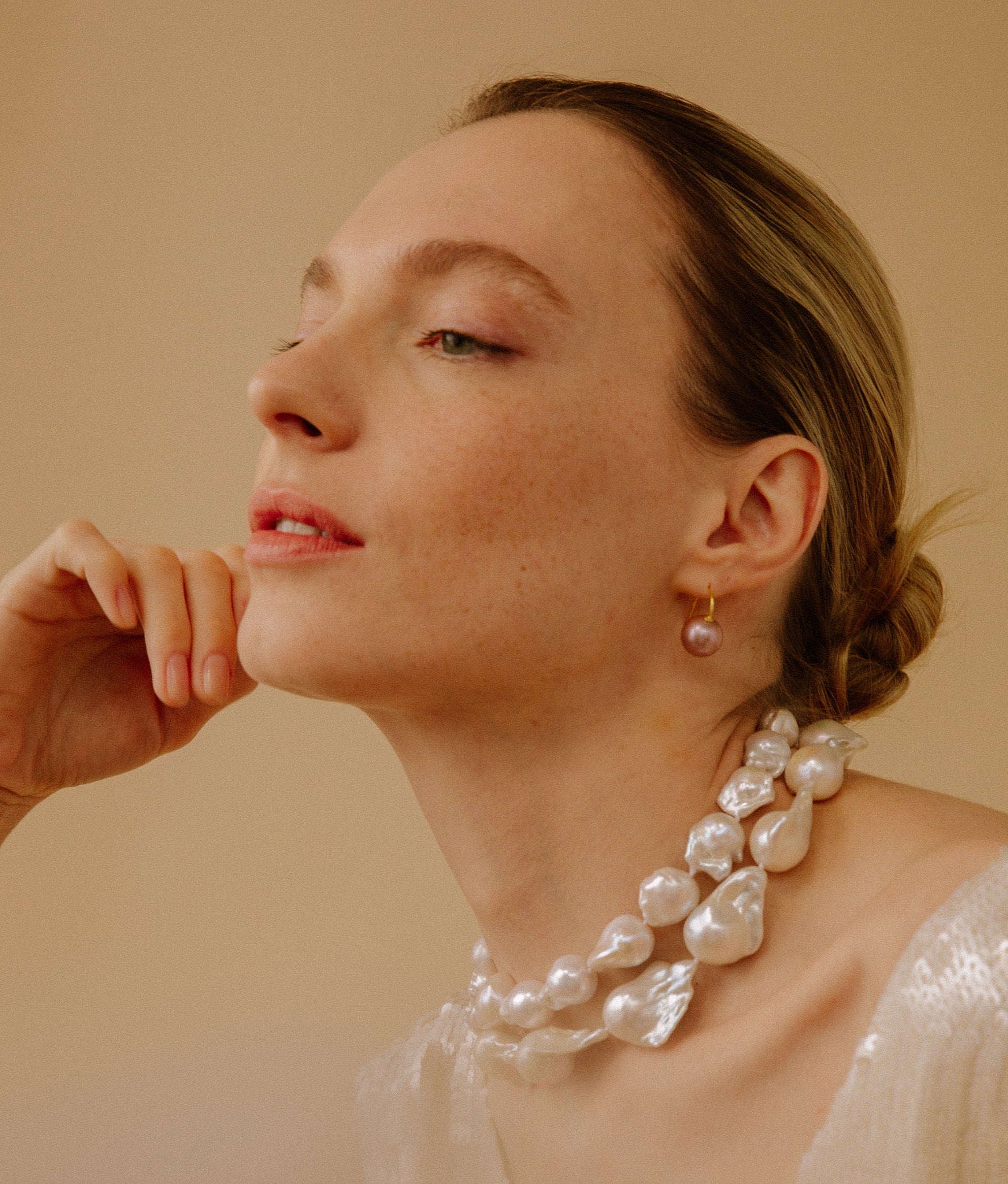 Model wears Claude Necklace styled with earrings.
