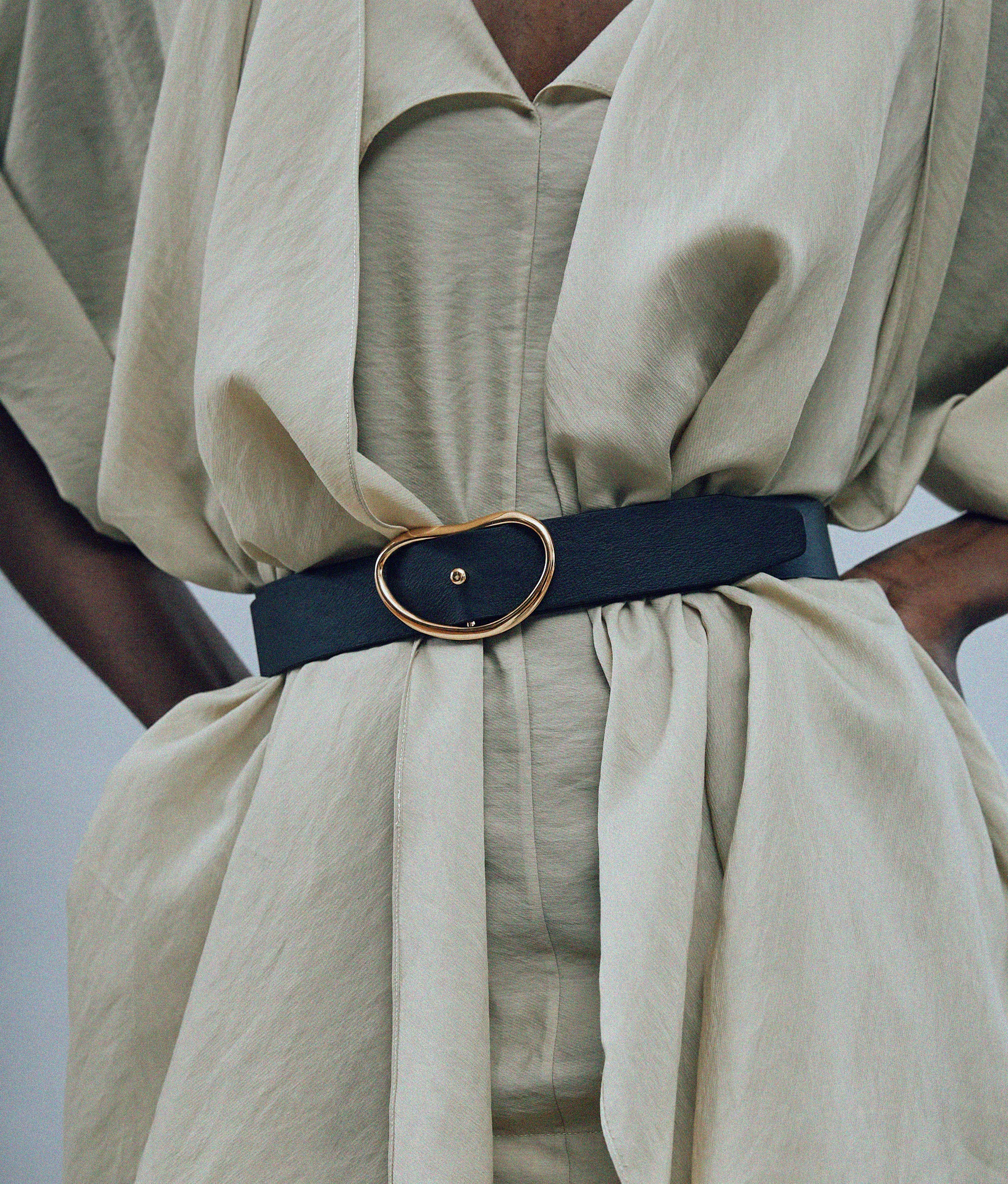 Close-up of model's torso in draped tan shirt and Wide Georgia Belt in Black.