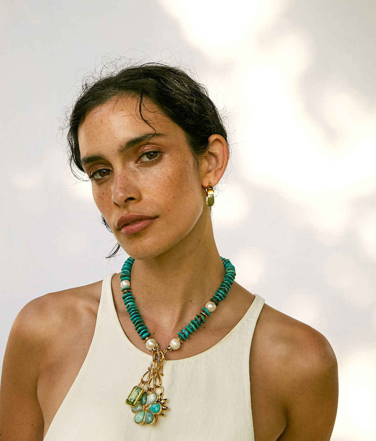Model wears white tank with Mood Necklace in Turquoise and assorted charms
