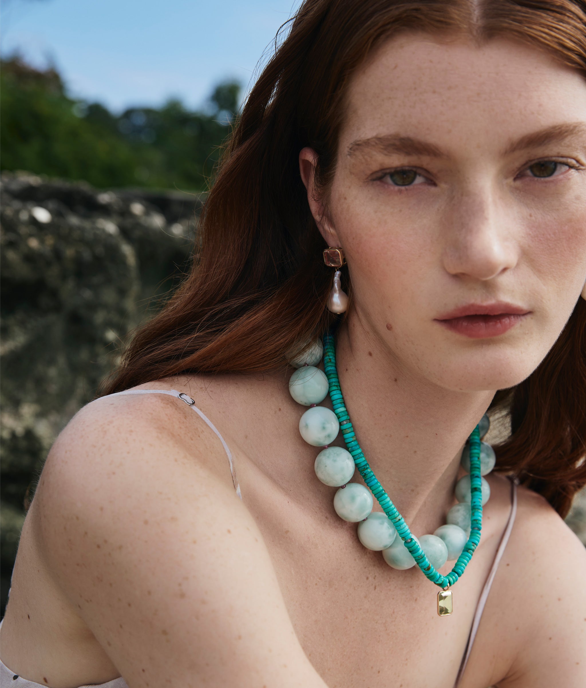 Close-up on model wearing Turquoise & Green Amethyst Necklace, Green Angelite Necklace and Juno Earrings.
