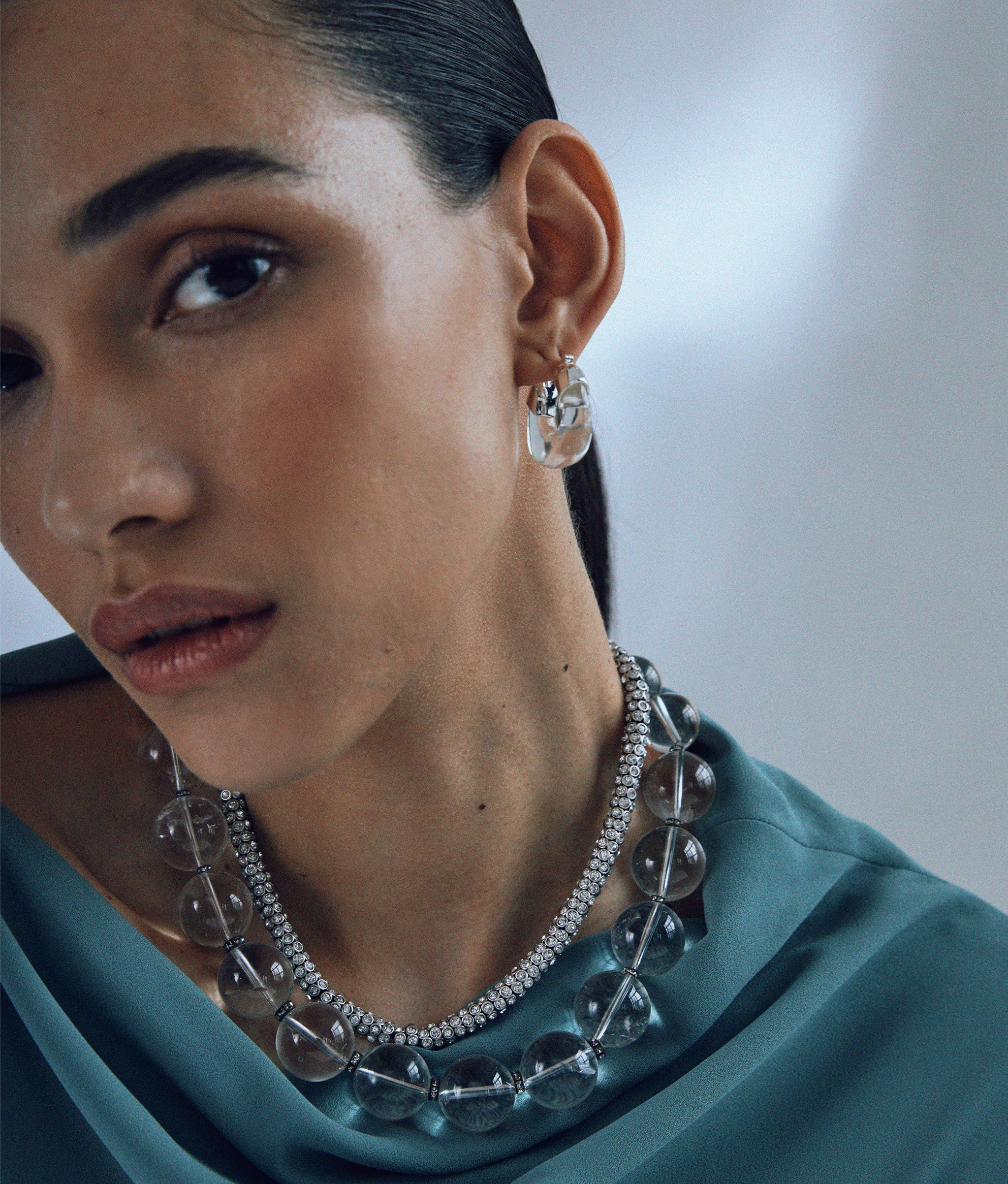 Model in teal top wears Mini Organic Hoops in Silver & Clear with Silver Moon Collar and Meteor Shower Necklace.