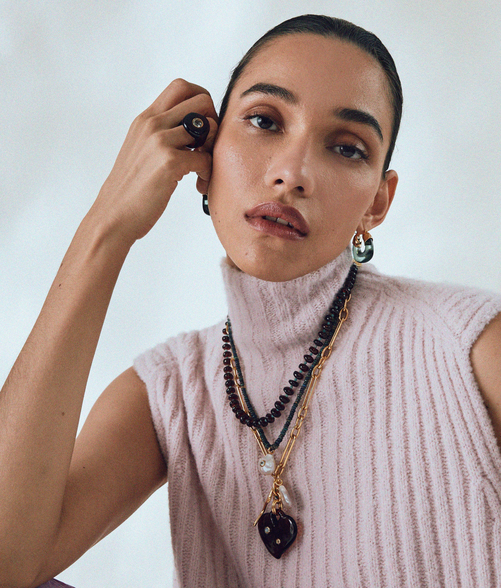 Model wears Murano Heart and Tola Necklace in Eclipse with Halo Ring and Organic Hoops.