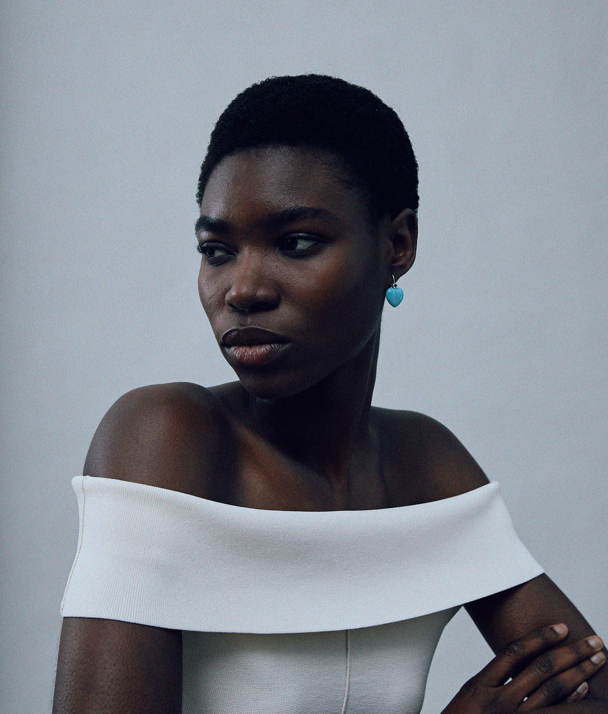 Model on grey background wearing the 14k Gold Amor Earrings in Tanzanite & Amazonite.