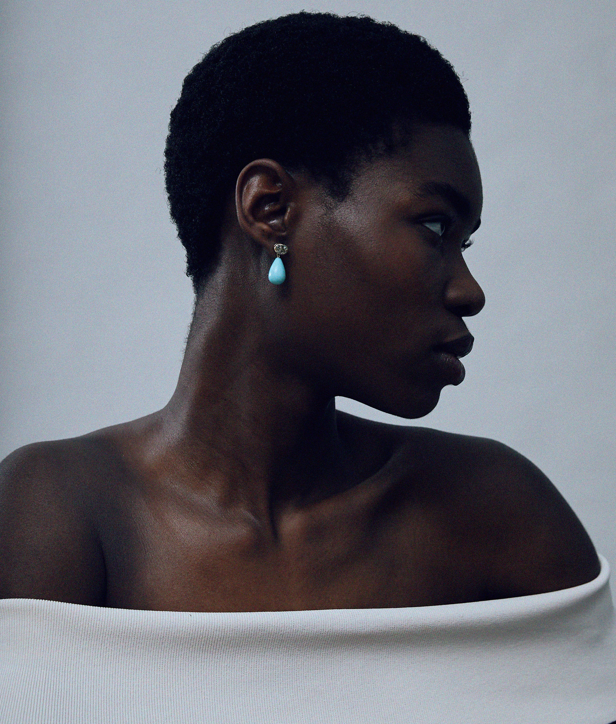 Model on grey background wearing the 14k Gold Drop Earrings in Green Amethyst & Amazonite.