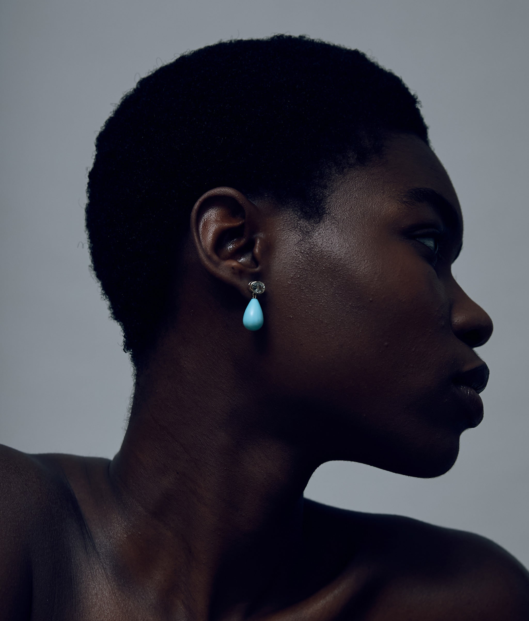 Another angle of model on grey background wearing the 14k Gold Drop Earrings in Green Amethyst & Amazonite.