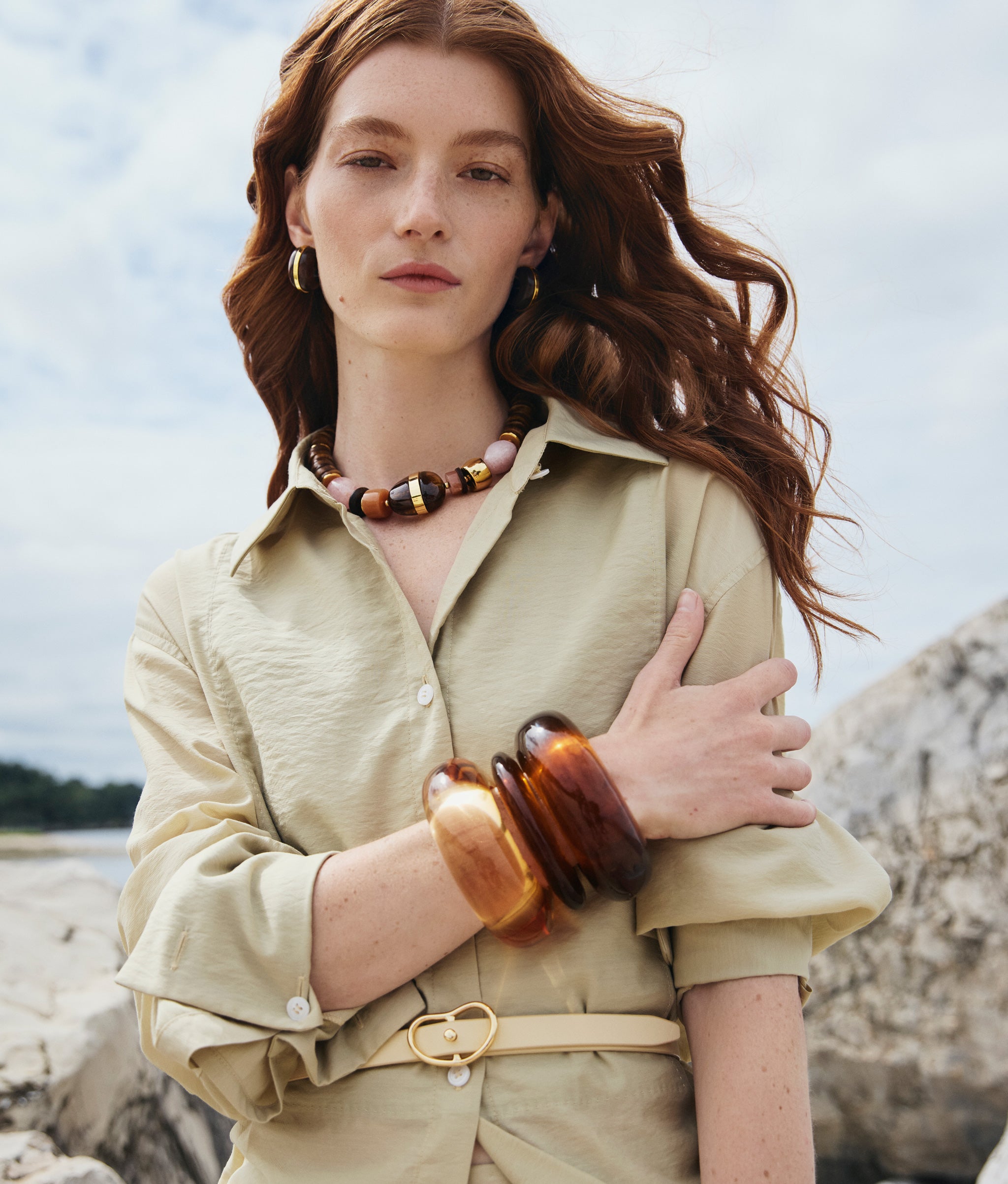 Model wears Neptune Collar in Terra, Halo Hoops in Acacia Wood and stacked resin cuffs.