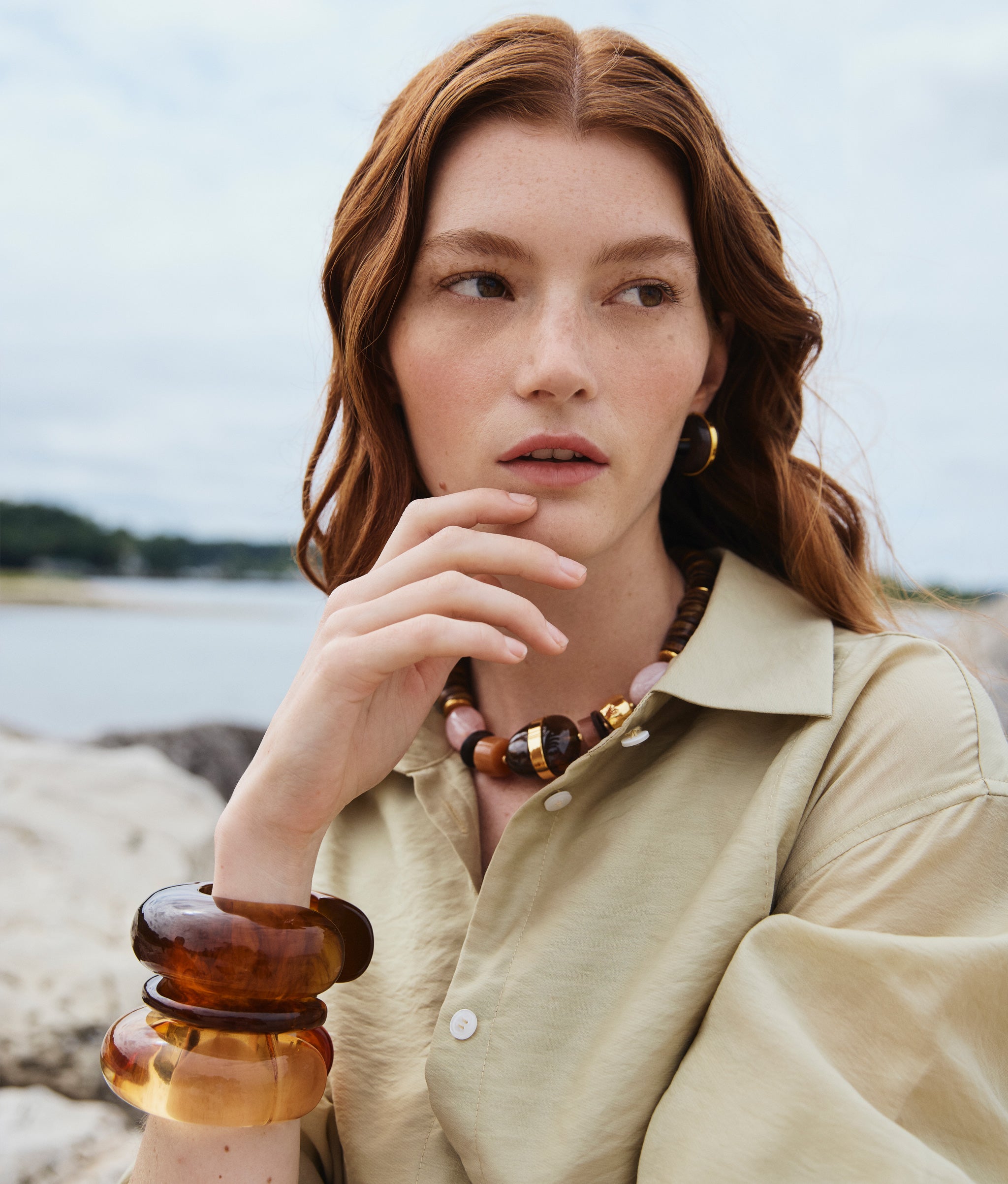 Model wears Neptune Collar in Terra, Halo Hoops in Acacia Wood and stacked resin cuffs.