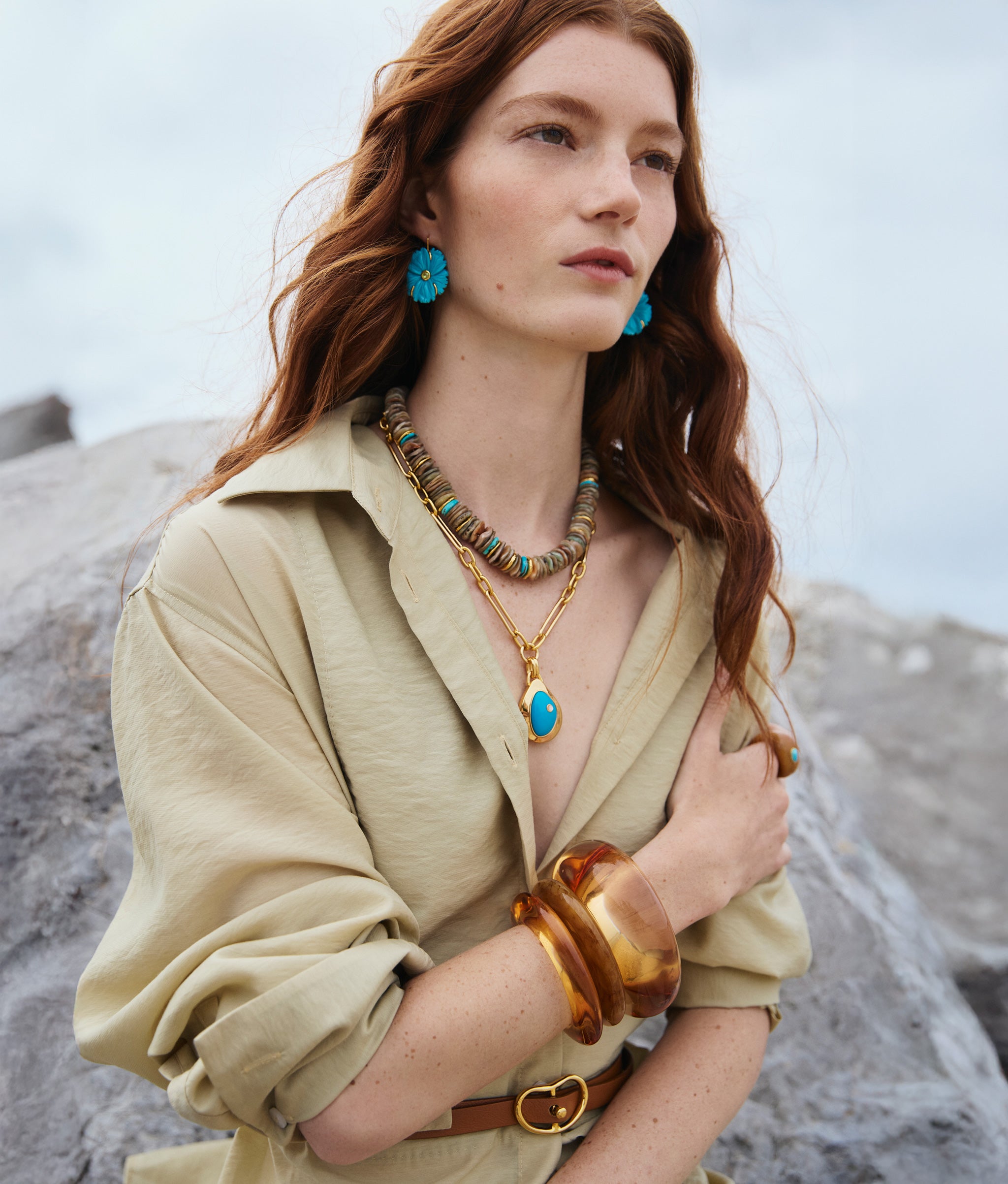 Model wears New Bloom Earrings in Cerulean, Blue Pond Necklace, Sand and Sky Necklace, and stacked resin cuffs.