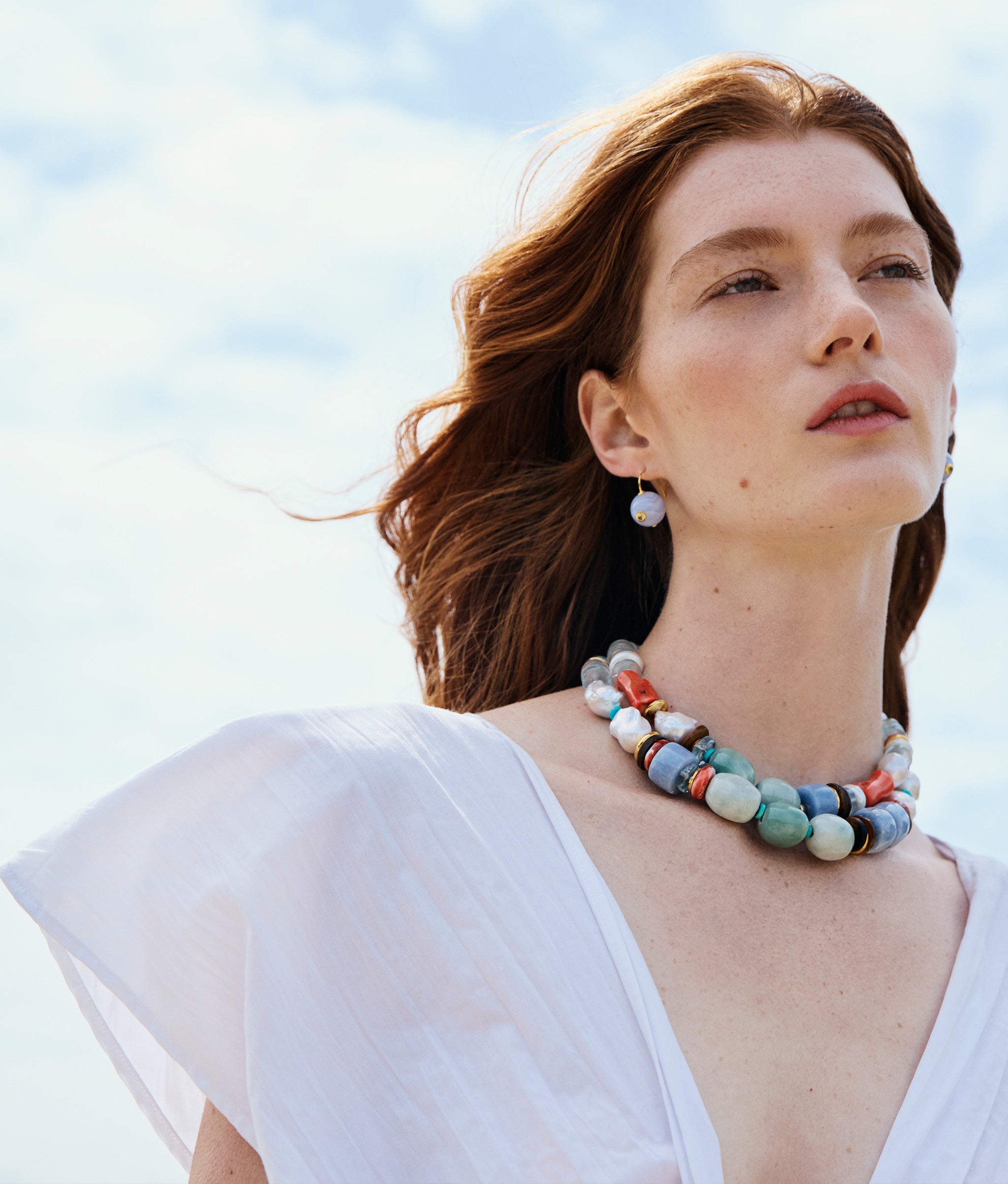 Model wearing Ariel Necklace in Cosmos and Comet Earrings in Blue Agate.