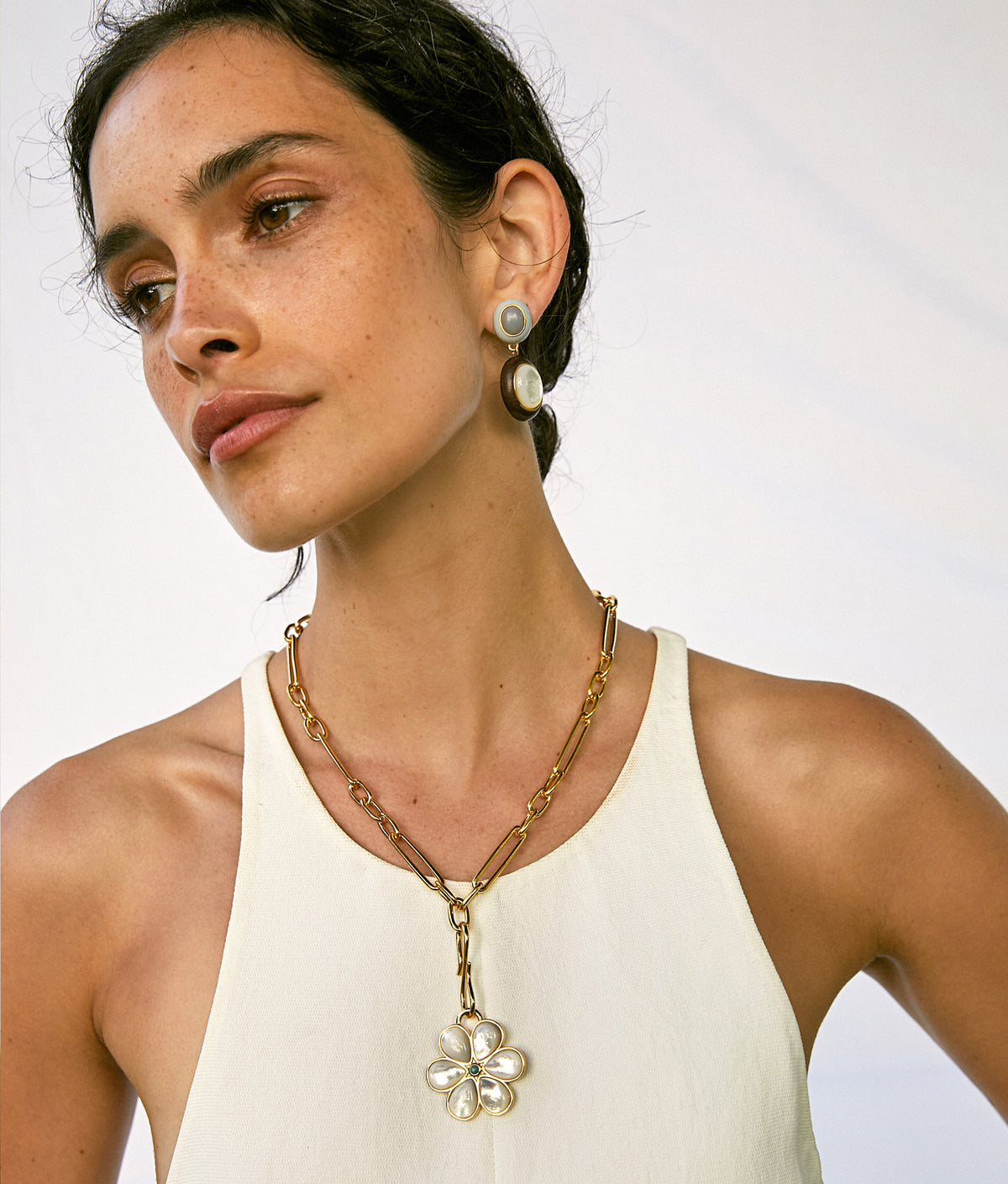 Model wears white tank top with Venice Chain and Daisy Pendant, and Papaya Earrings.