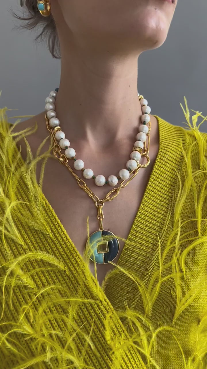 Video of model in yellow feather sweater wearing Pacifica Pearl Collar and other jewels