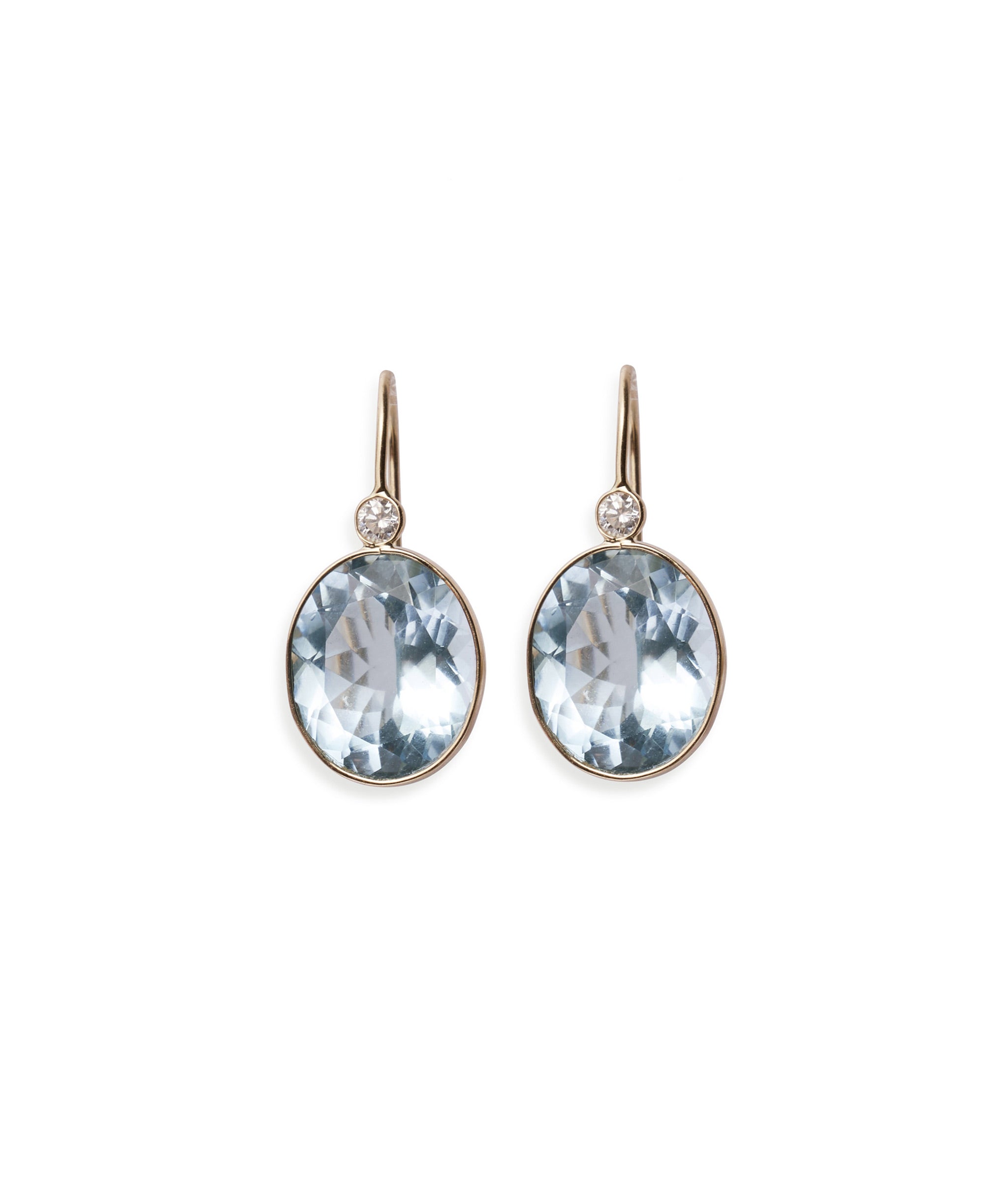 Pool Earrings in Blue Topaz & Diamond. Faceted blue topaz oval earrings with 14k gold bezels and diamond detail.