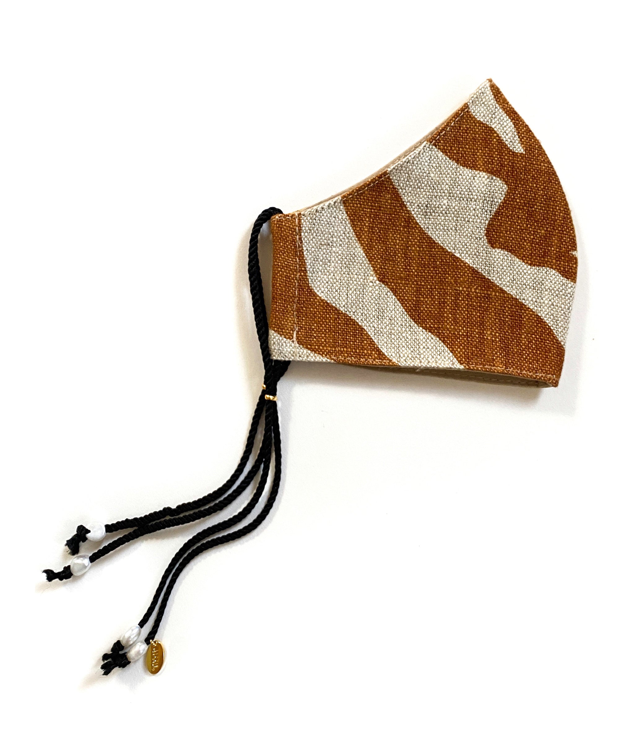 Side view of Face Mask in Safari showing brown zebra print linen, black cord straps and freshwater pearl details.