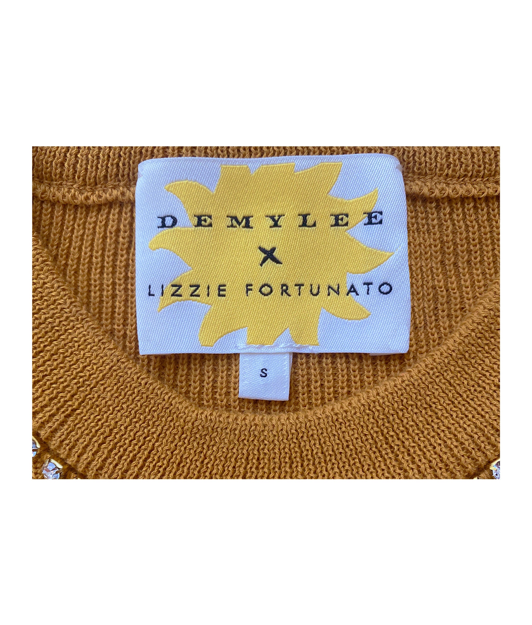 Close-up of knit on The Uptown Sweater, with rhinestone chain and yellow starburst DemyLee x Lizzie Fortunato label.