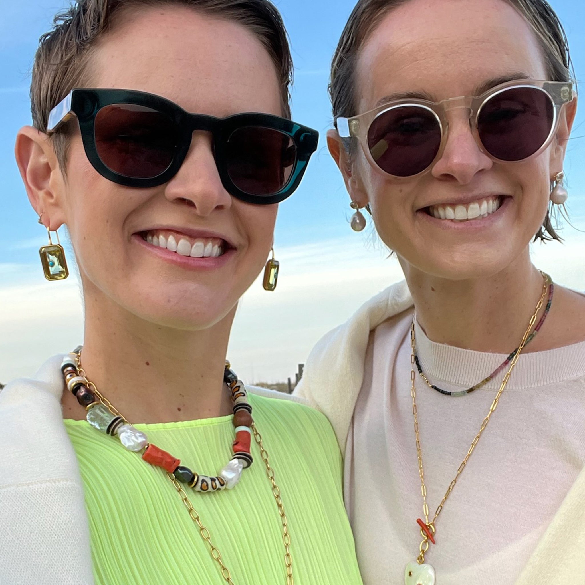 Twins Lizzie and Kathryn wear sunglasses and assorted necklaces and earrings