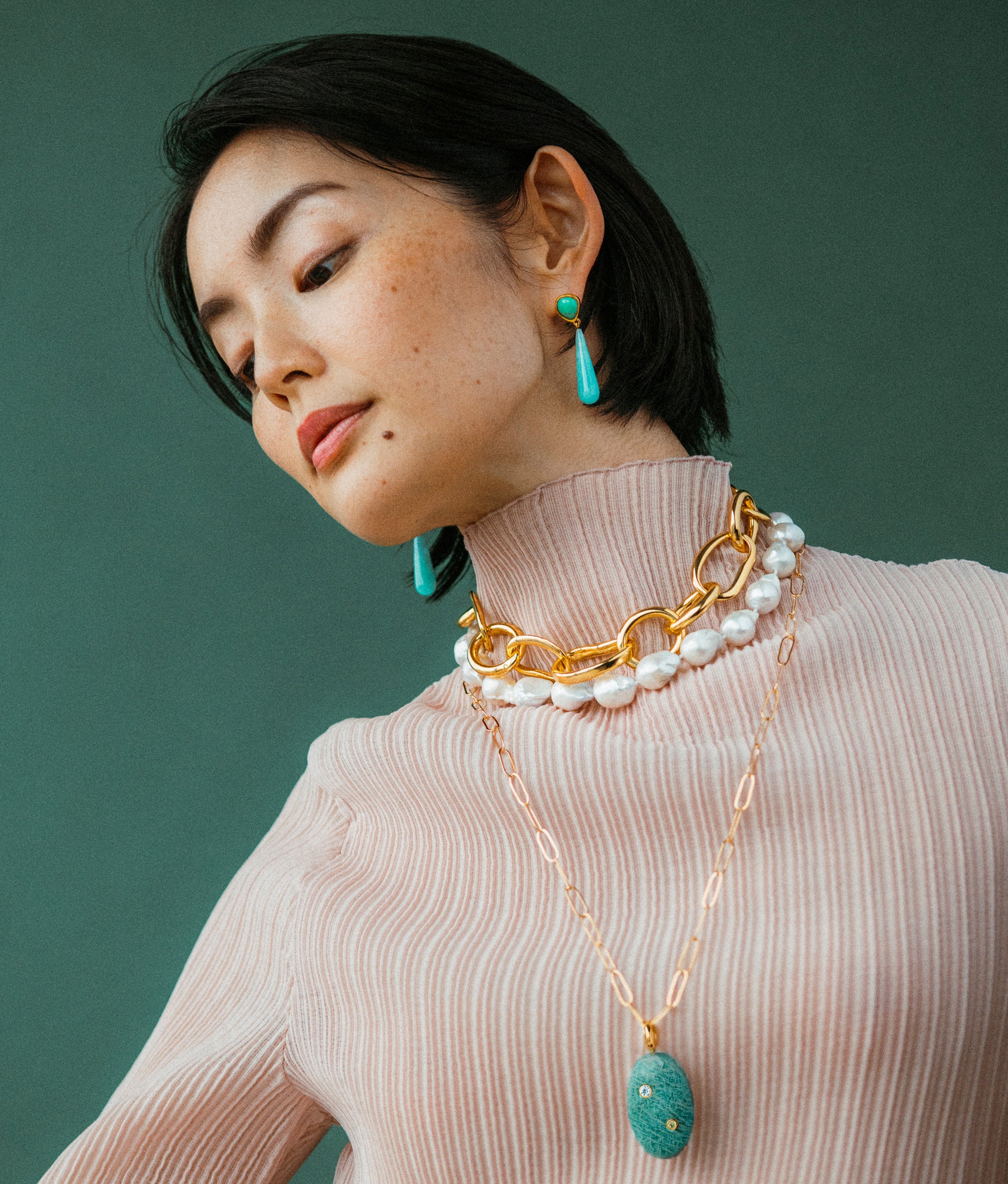 Model wears Claude Necklace styled with Porto Chain and Isadora pendat Necklace.