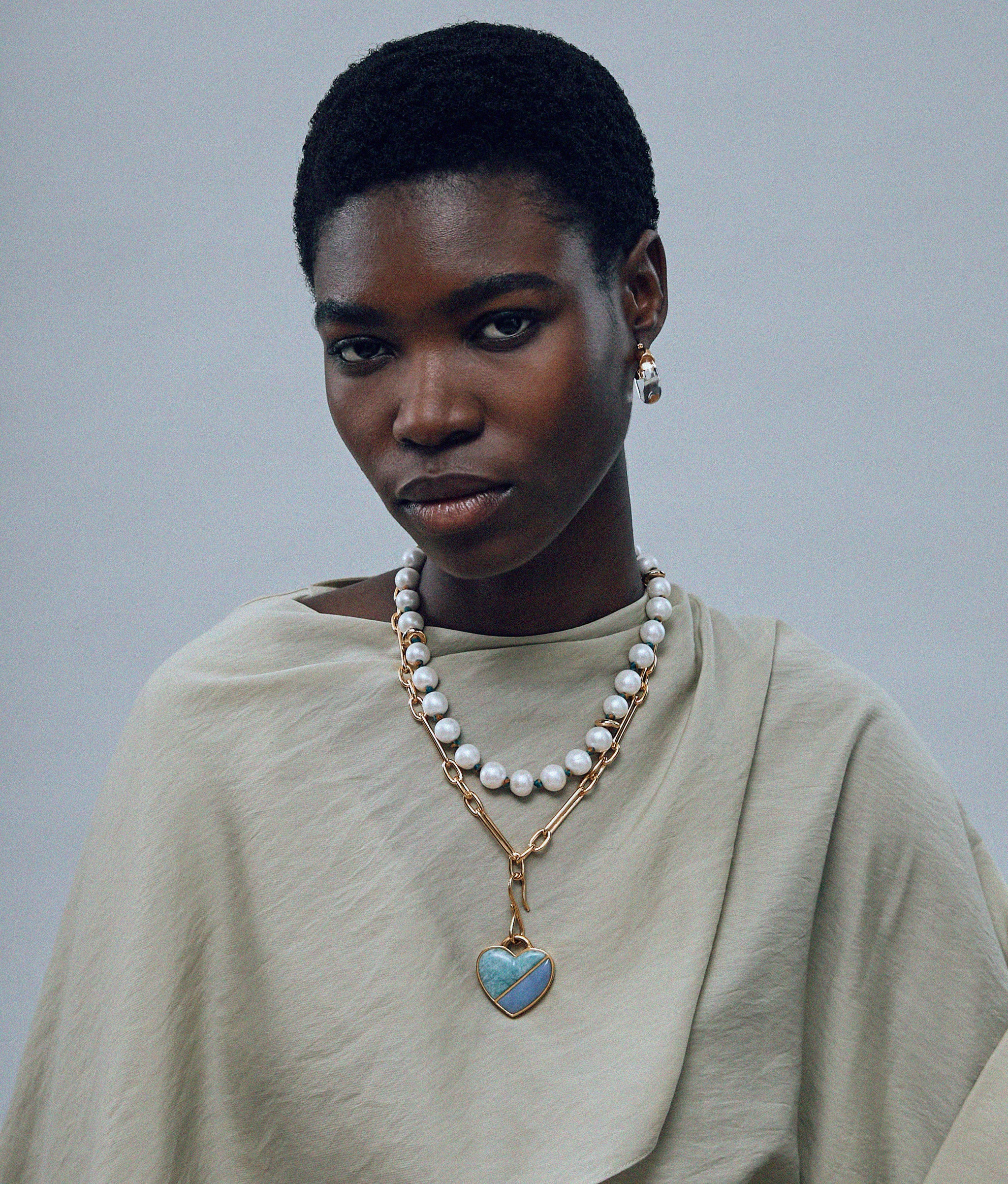 Model on grey background wearing Pacifica Pearl Collar. 