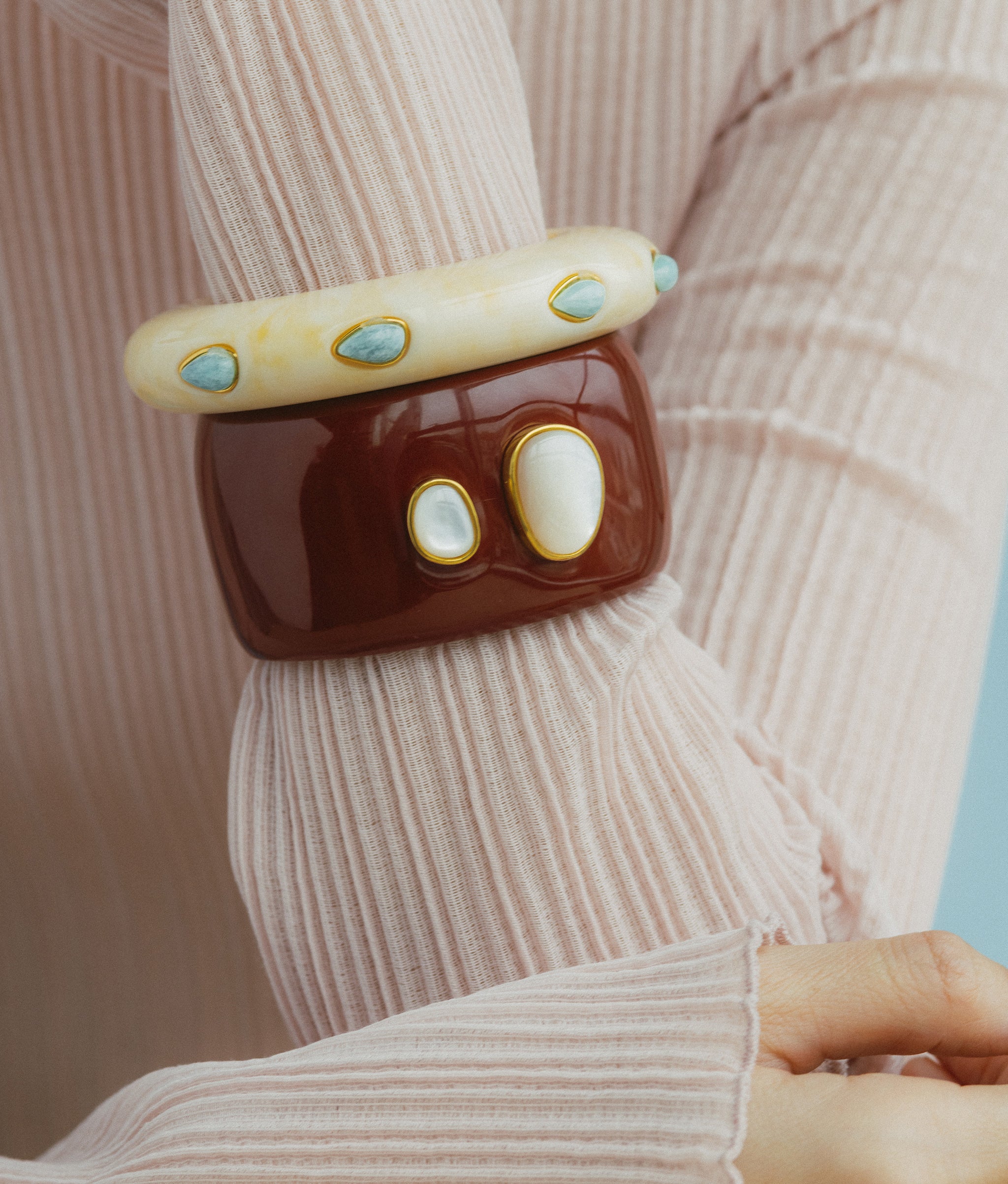 Close-up of Lanna Cuff in Pearl styled on a model along with Ridge Cuff.