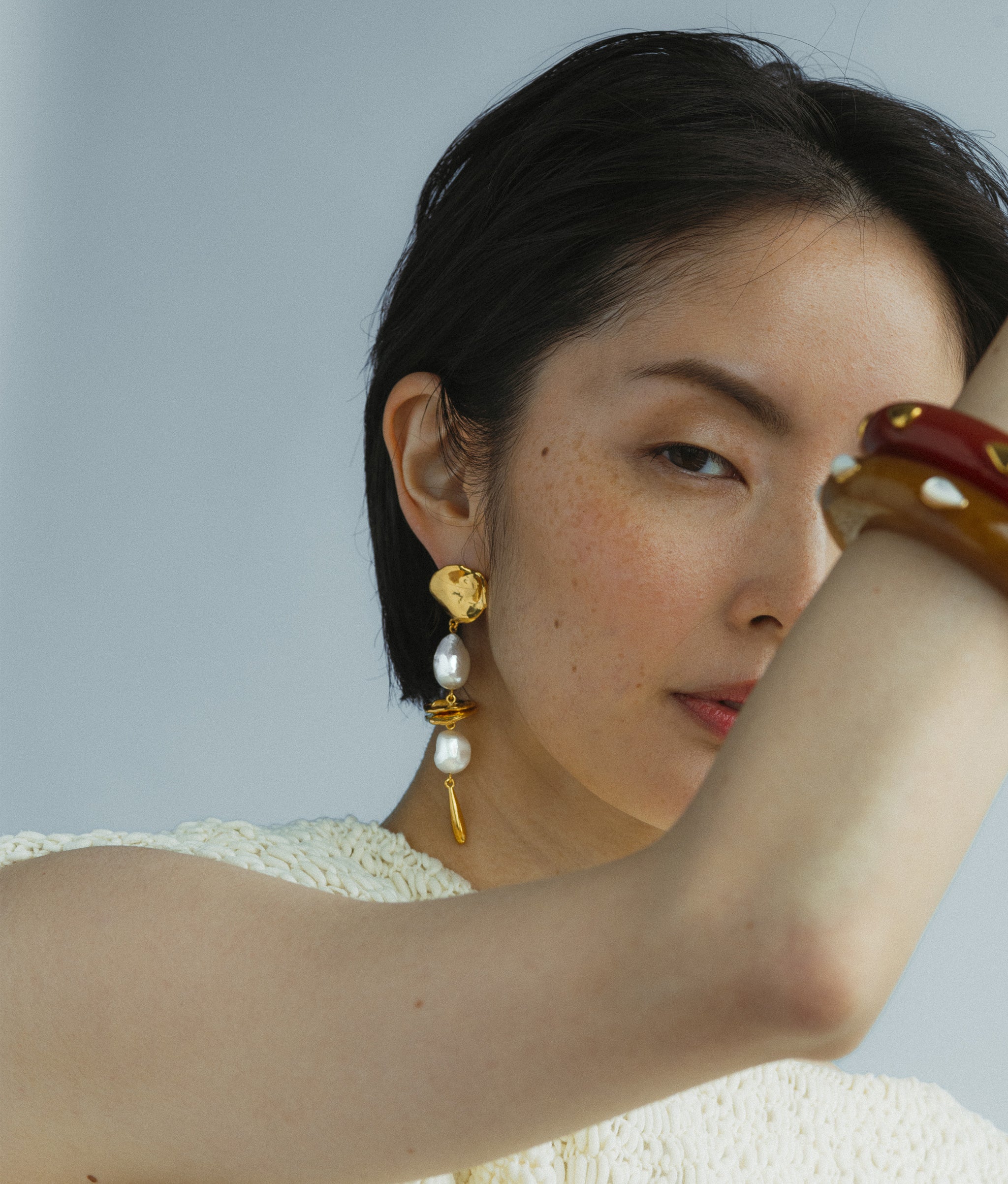 Close-up of model wearing Gold Mine Earrings.