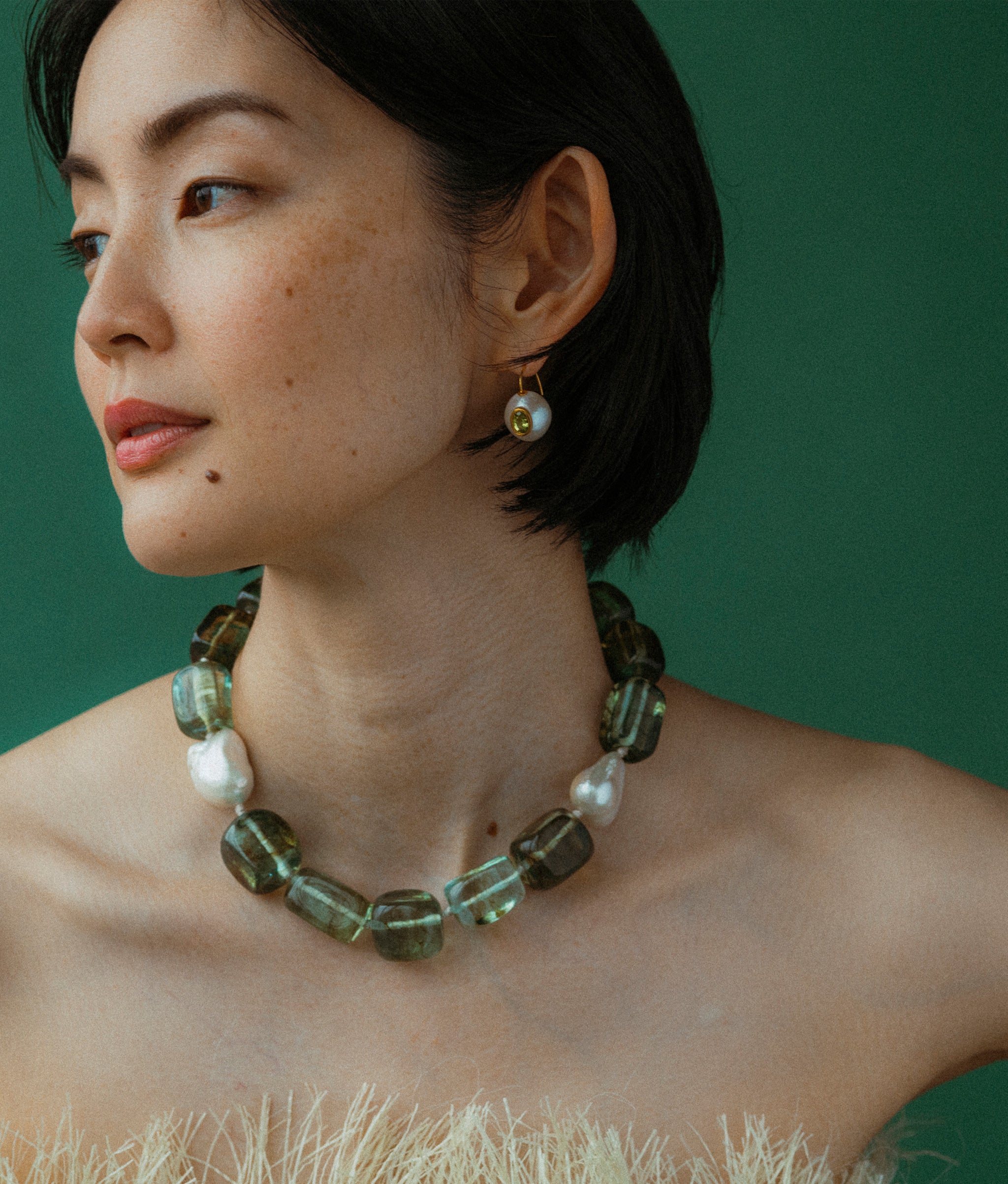 Model wears Delphine collar styled with Pearl Pablo Earrings in Peridot.