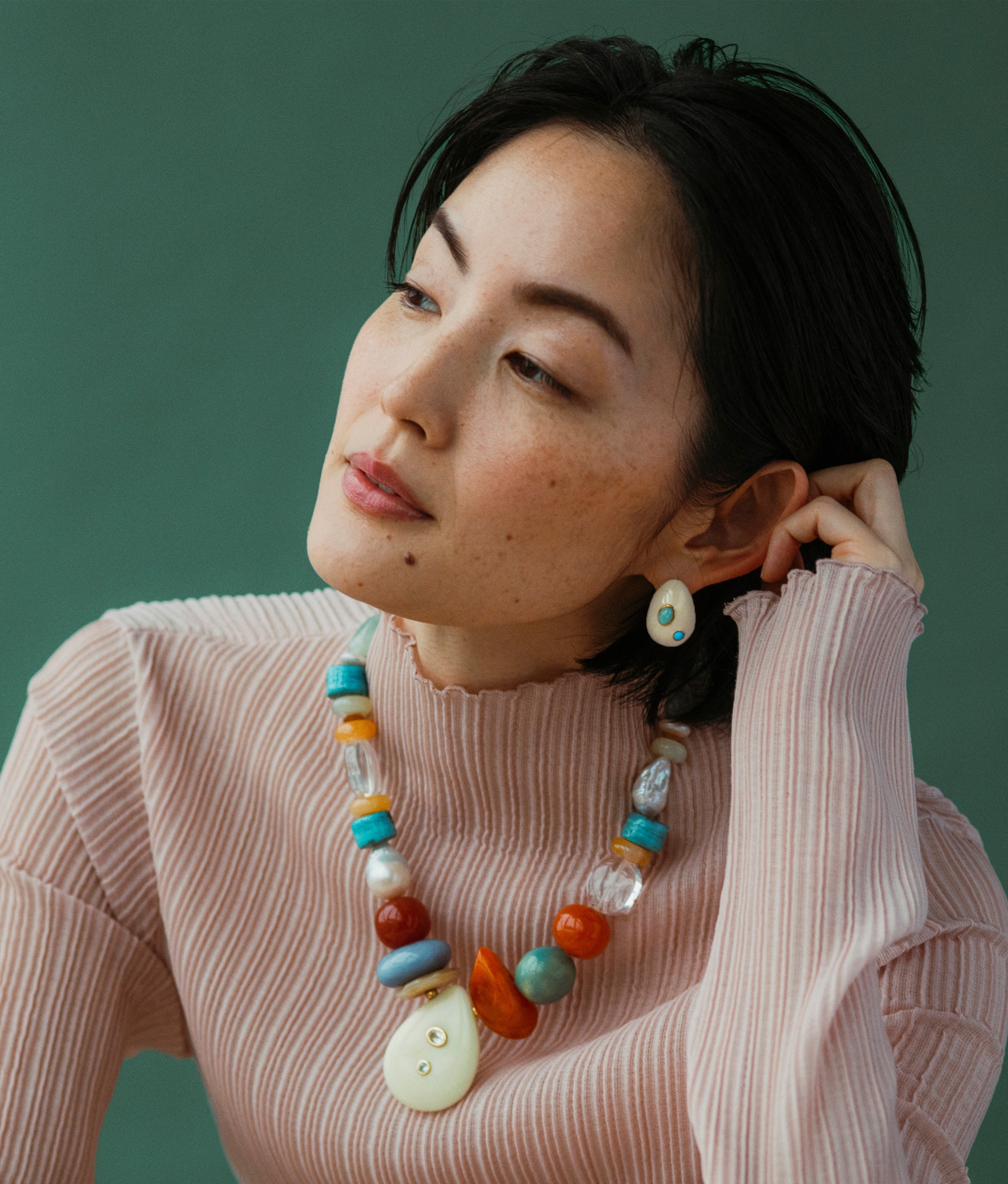 Model wears Mini Arp Earrings In Studded Cream with Artifact Necklace and a pink long-sleeve.