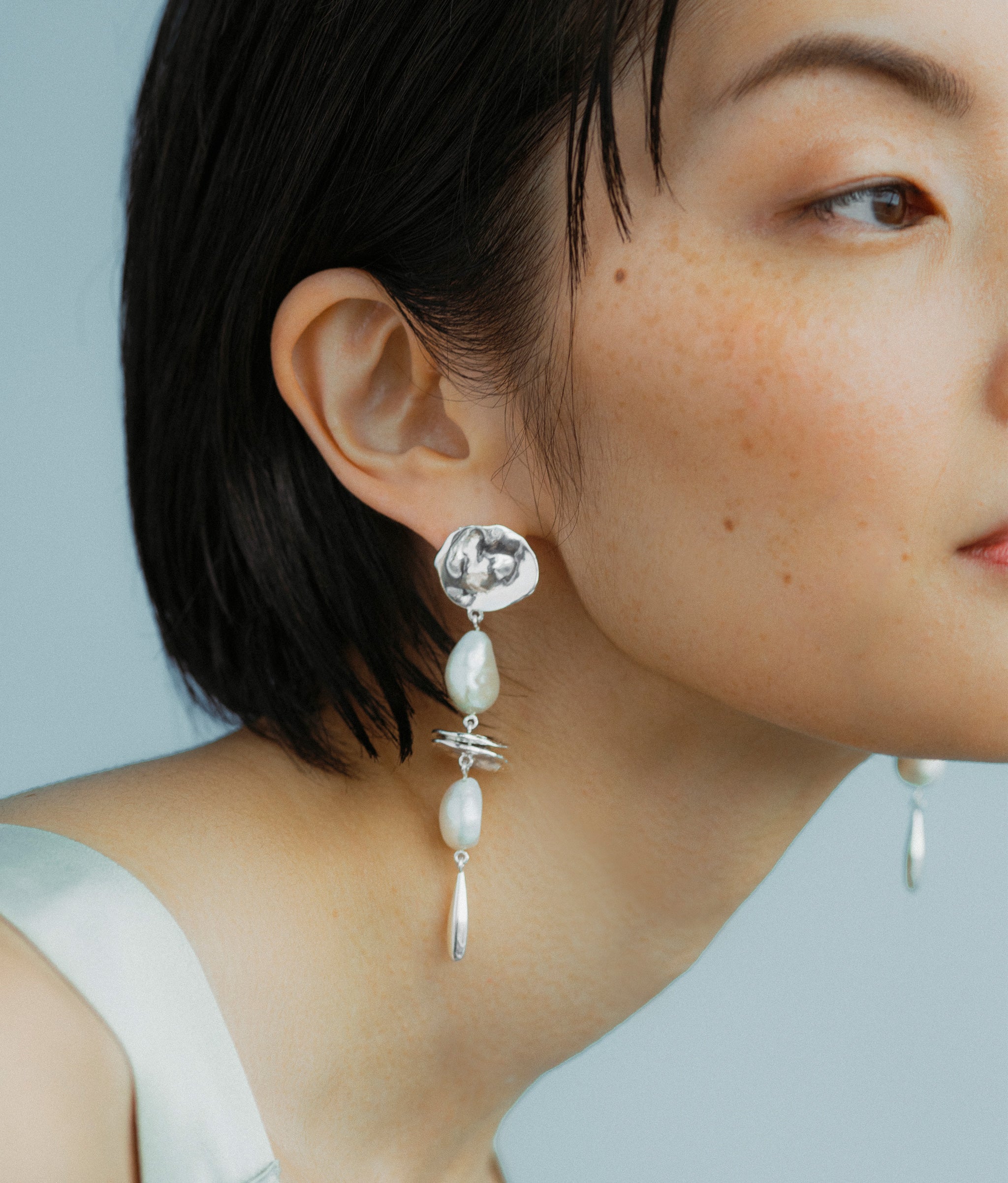 Model wears SIlver Mine Earrings.