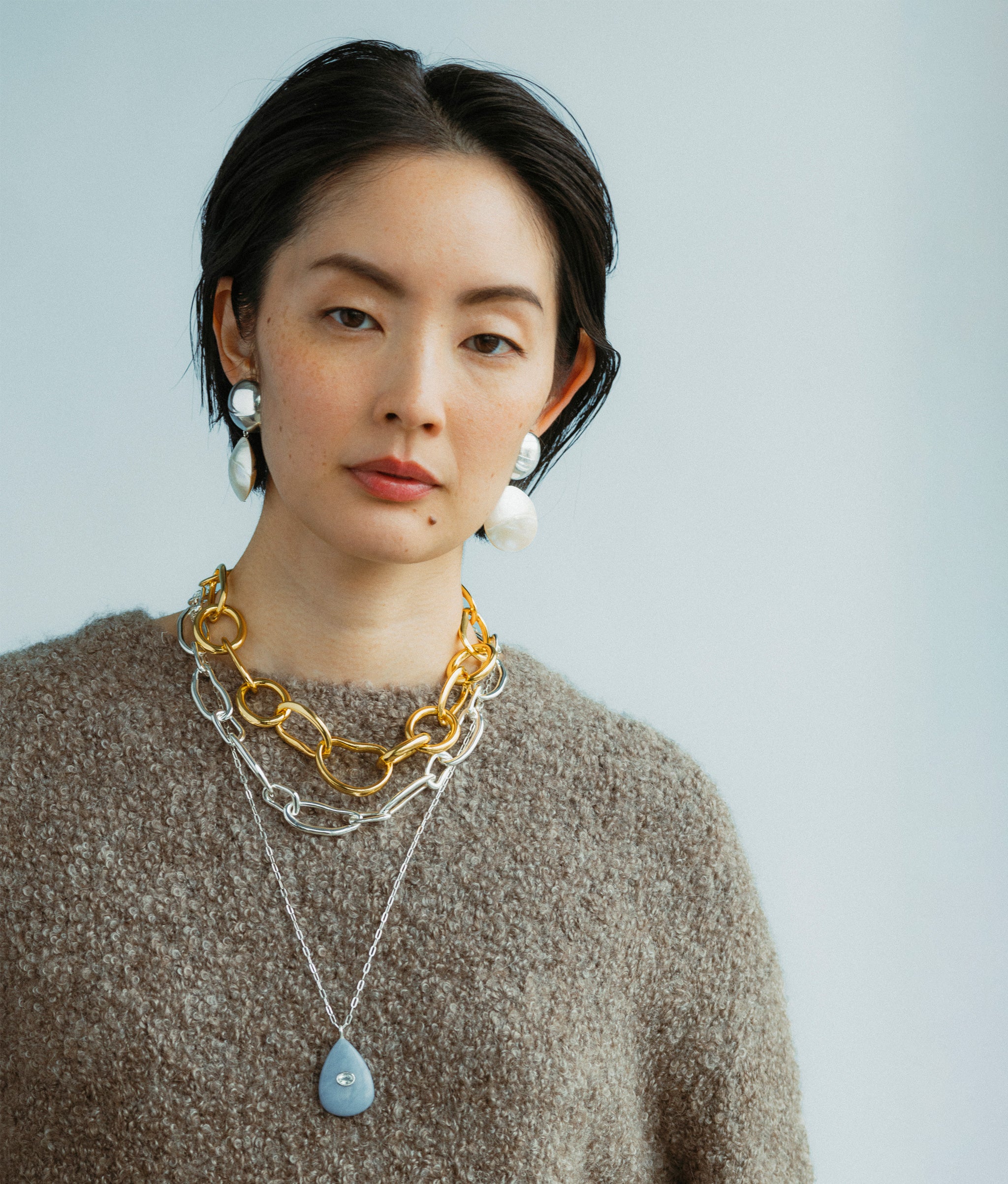 Model wears Rodan Pearl Earrings along with Avalon necklace overlayed by Collage Chain Necklace in Silver and Porto Chain.