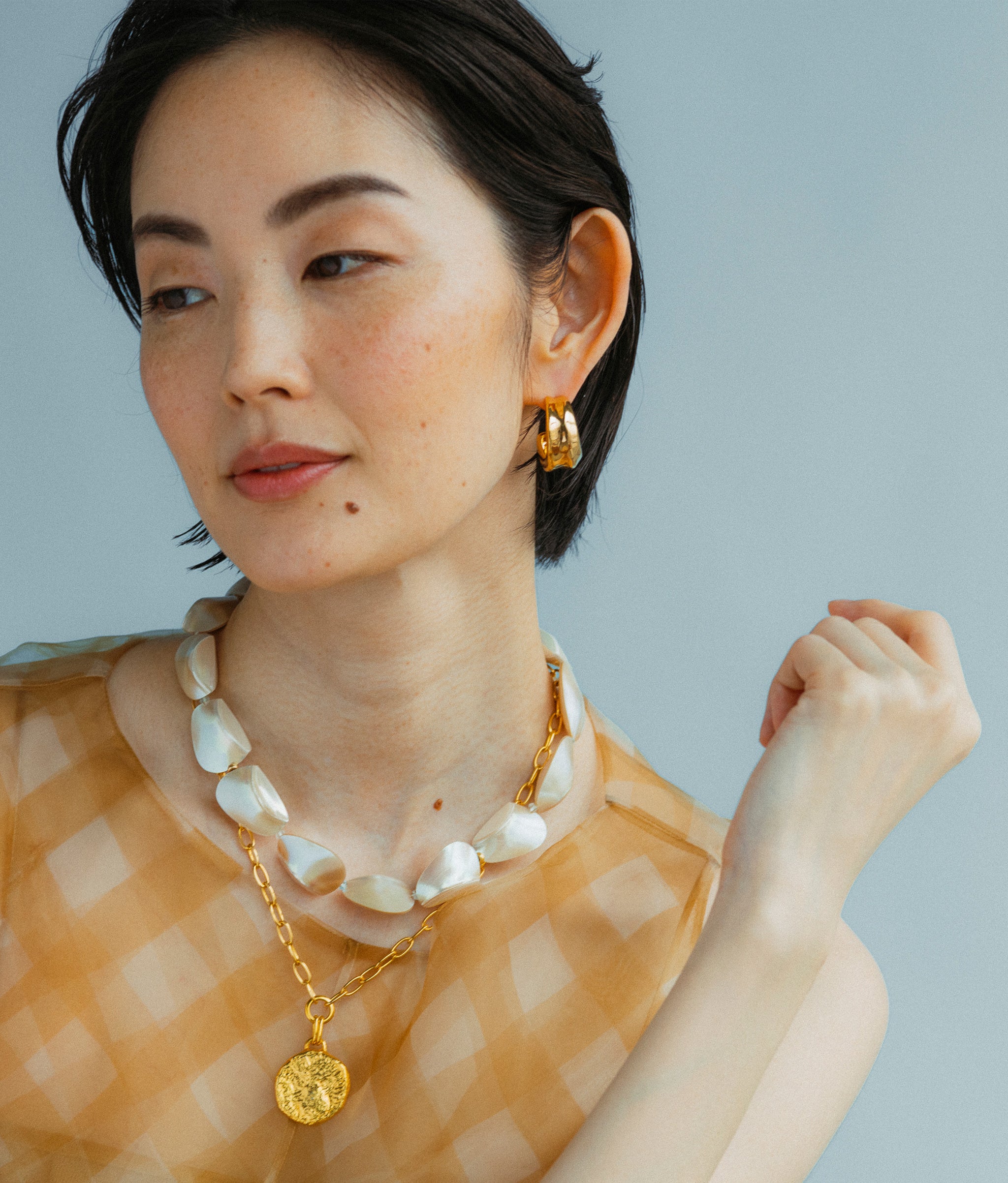 Model wears Pas De Deux Necklace with Onda Hoops In Gold Earrings