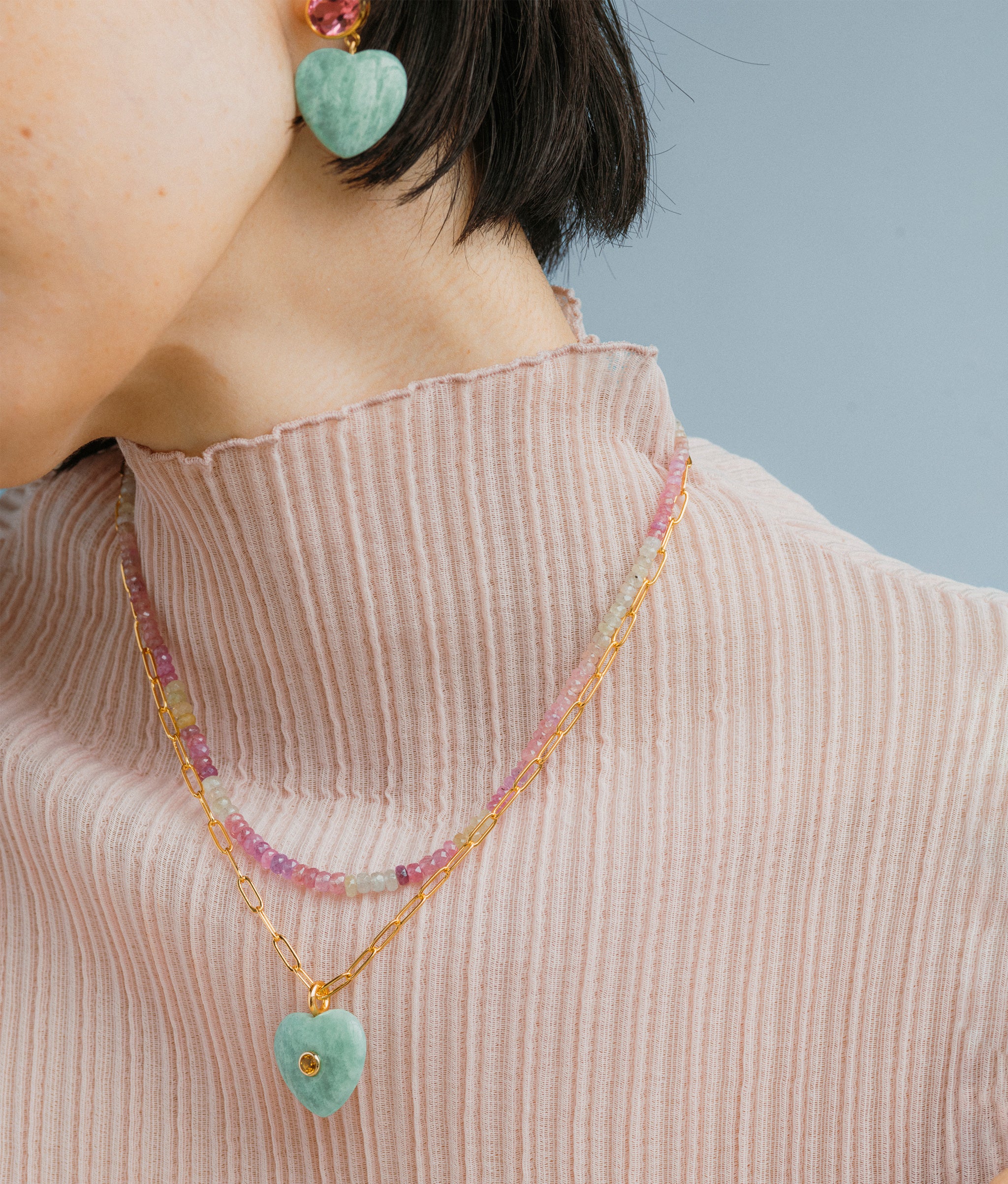 Close-up of model wearing Lamai Heart Necklace in Berry