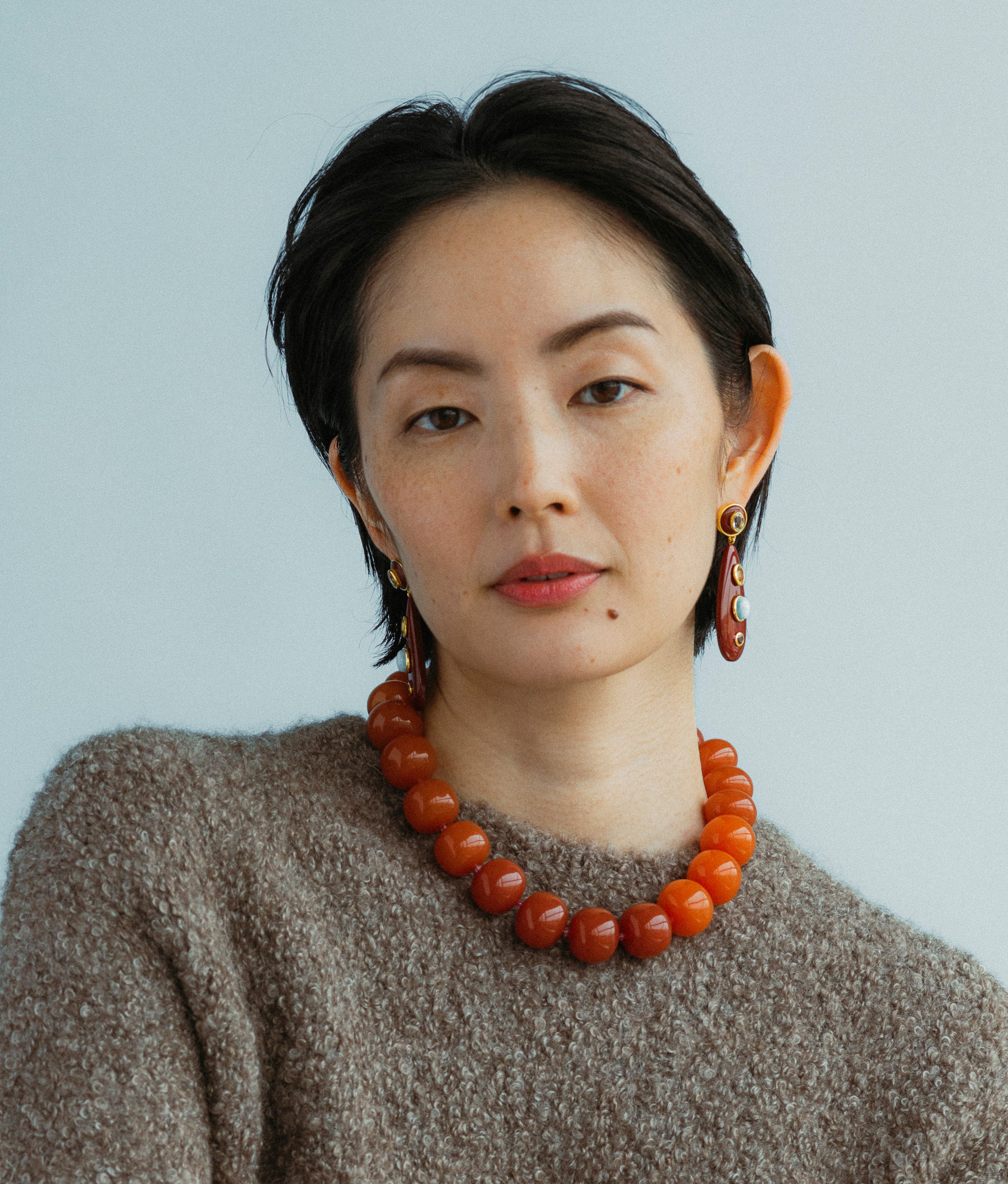 Model wears Olympia Collar in Spice paired with Torre Earrings in Chestnut