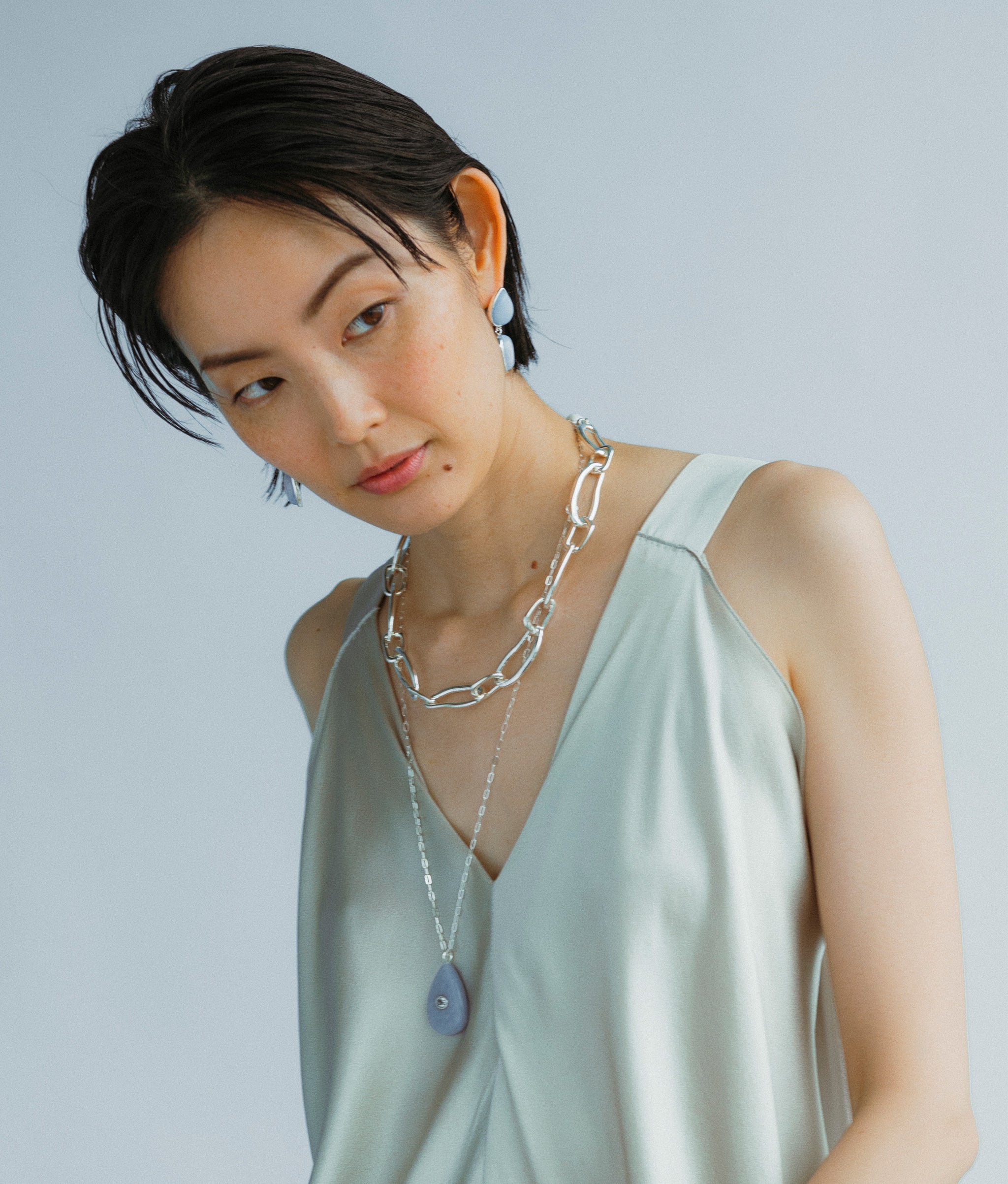 Model wears Collage Chain Necklace in Silver with Avalon Necklace and Electra Earrings in Angelite.