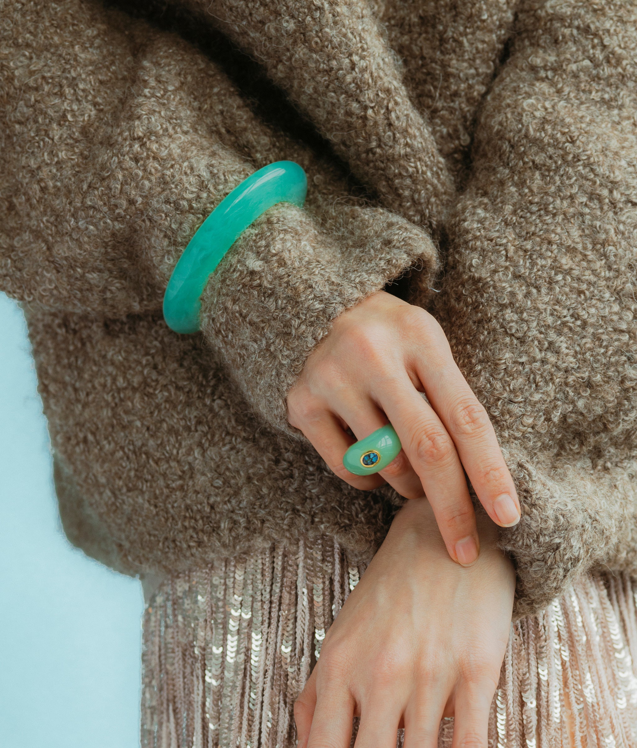 Close-up of Monument Ring in Sage and Ridge Cuff In Jade Green styled on model.