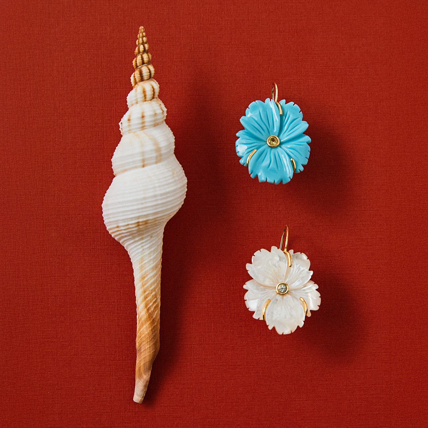 Red background flatly with shell and New Bloom Earrings in Cerulean and Pearl
