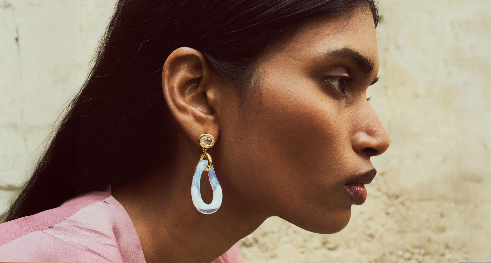 Model in profile wears pink top and Galina Earrings in Opalescent