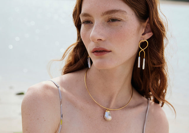 Model wears Etienne Earrings and Best Lady Necklace in Pearl