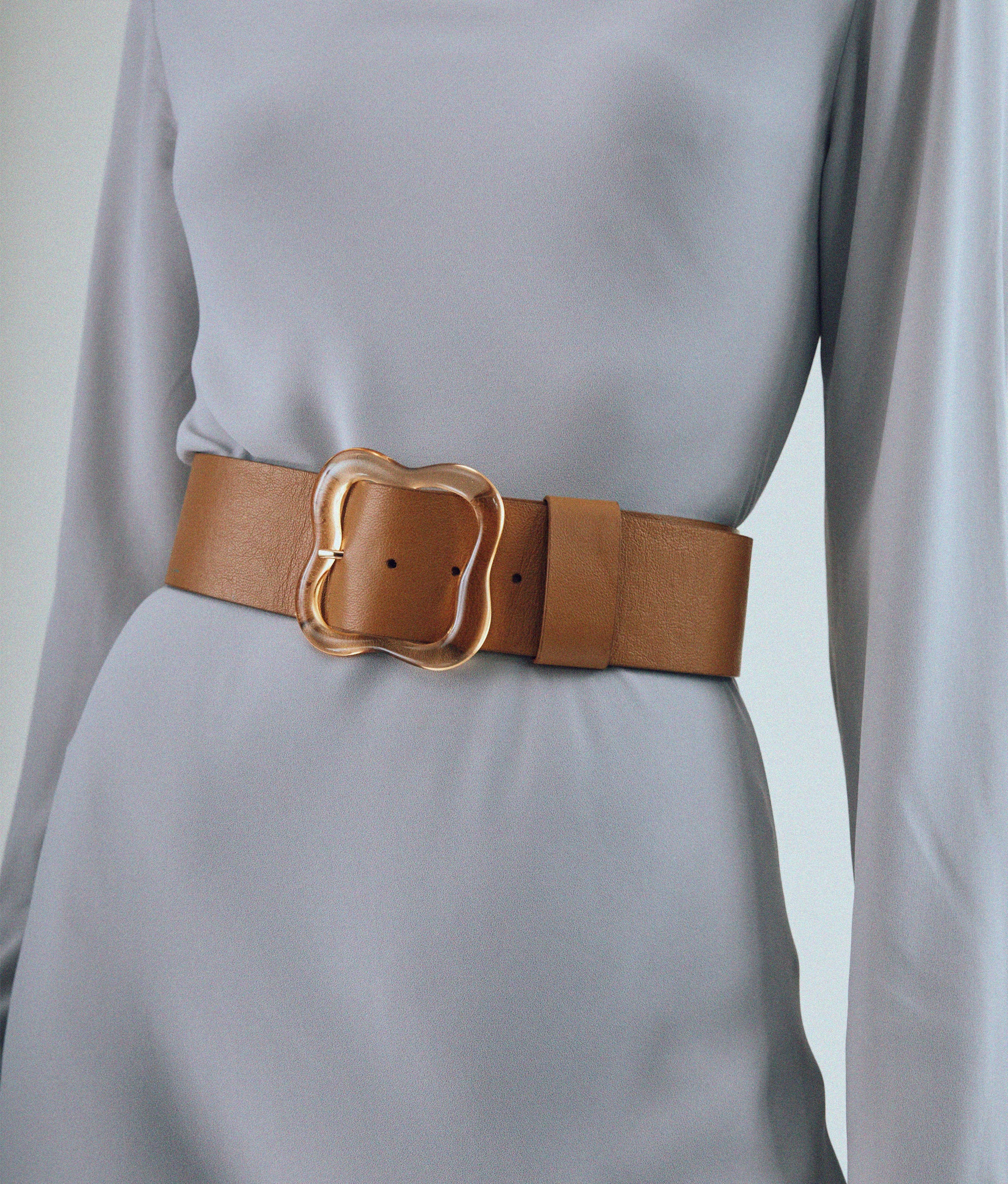 Our Florence Belt in Amber styled in model. Designed as a waist belt; when in doubt size up.