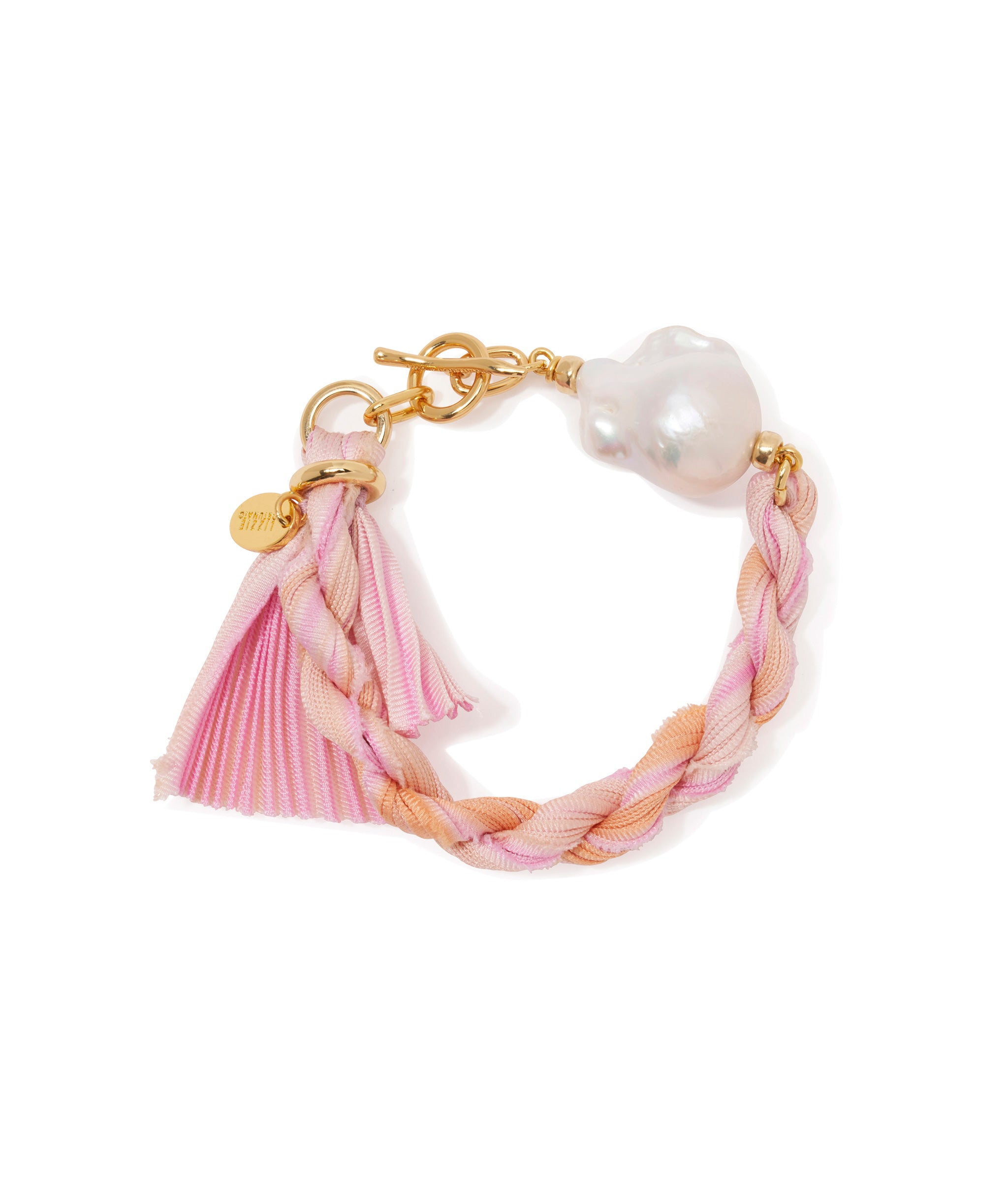 Shibori Ribbon Bracelet in Rose. Light pink shibori silk ribbon, large freshwater pearl and gold-plated toggle closure.
