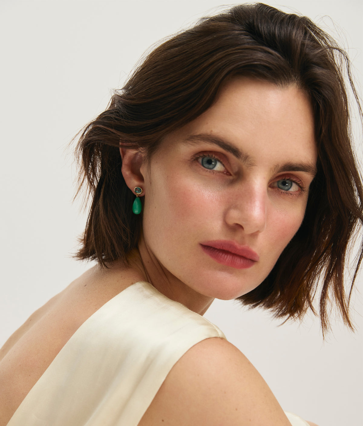 Model in cream satin blouse wears 14k Gold Drop Earrings in Green Topaz & Chrysoprase