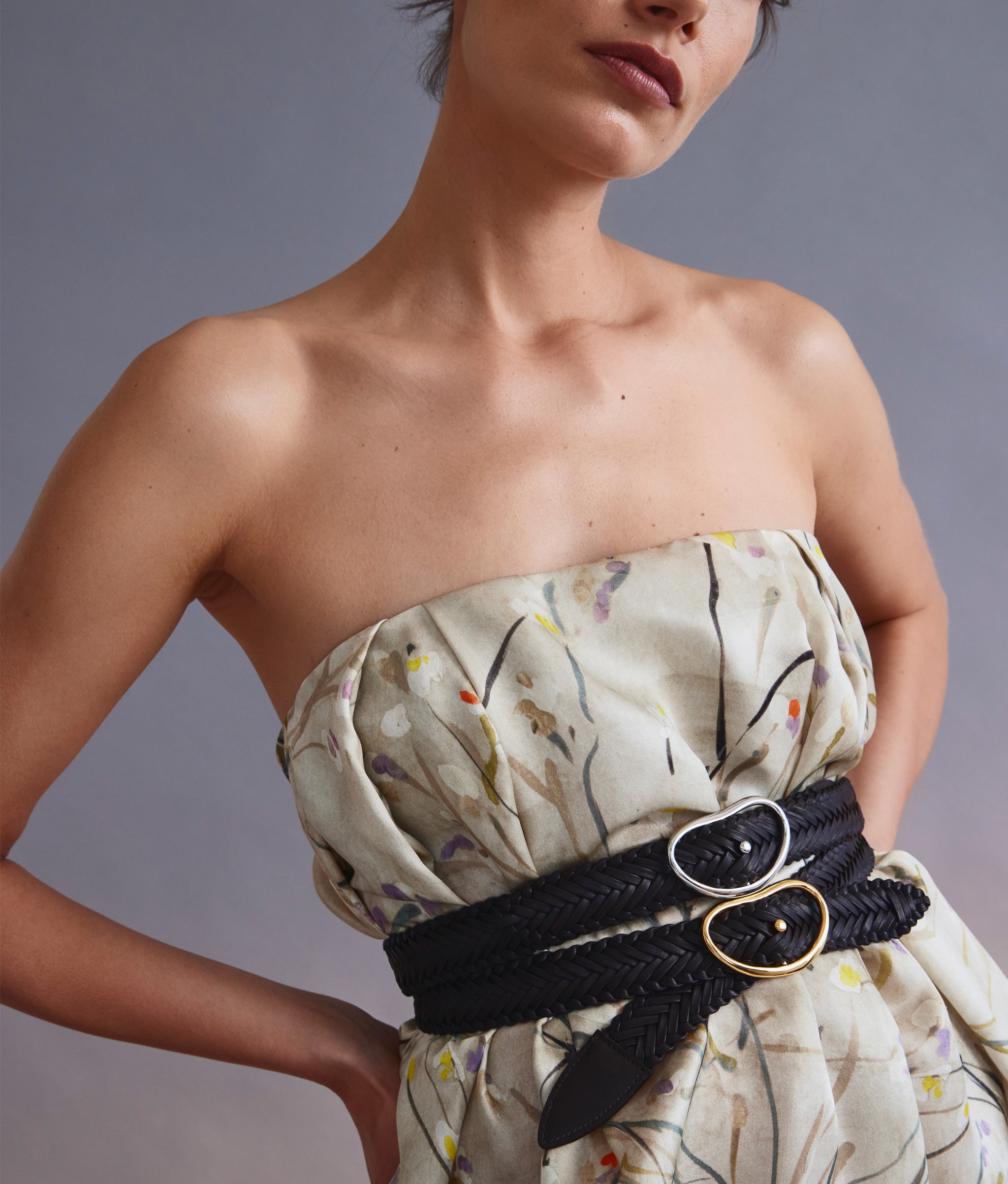 Close-up of model on grey background wearing the Wide Georgia Belt in Woven Java and Silver.