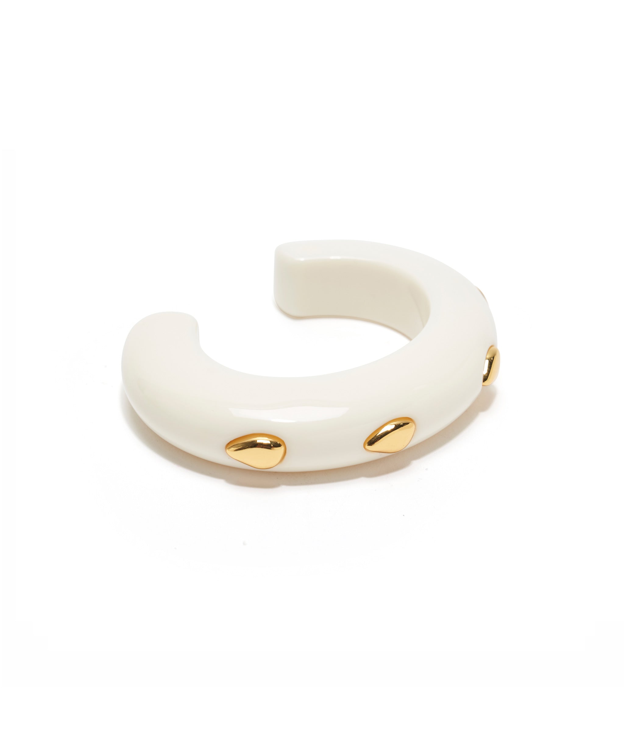 Ridge Cuff in Alabaster and Gold stud is an Ivory-colored, thin acrylic domed cuff with abstract gold-plated brass dots.