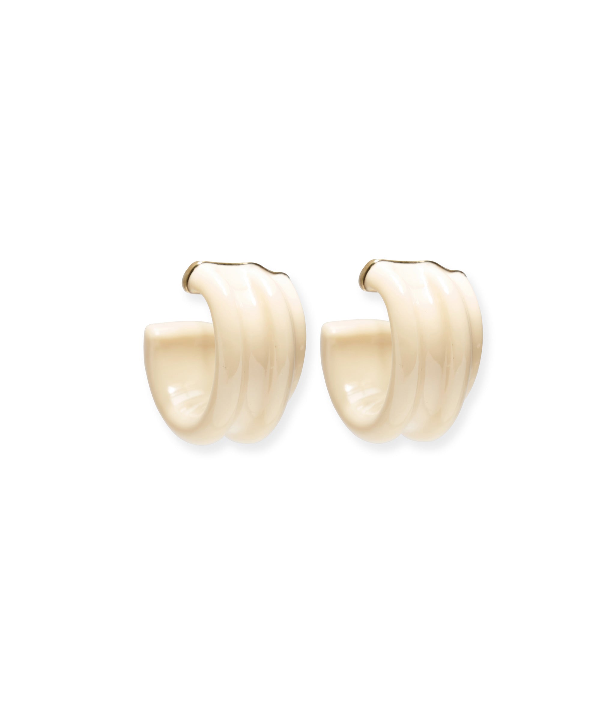 These sculptural hoops are crafted from ivory-colored resin and tipped with gold.