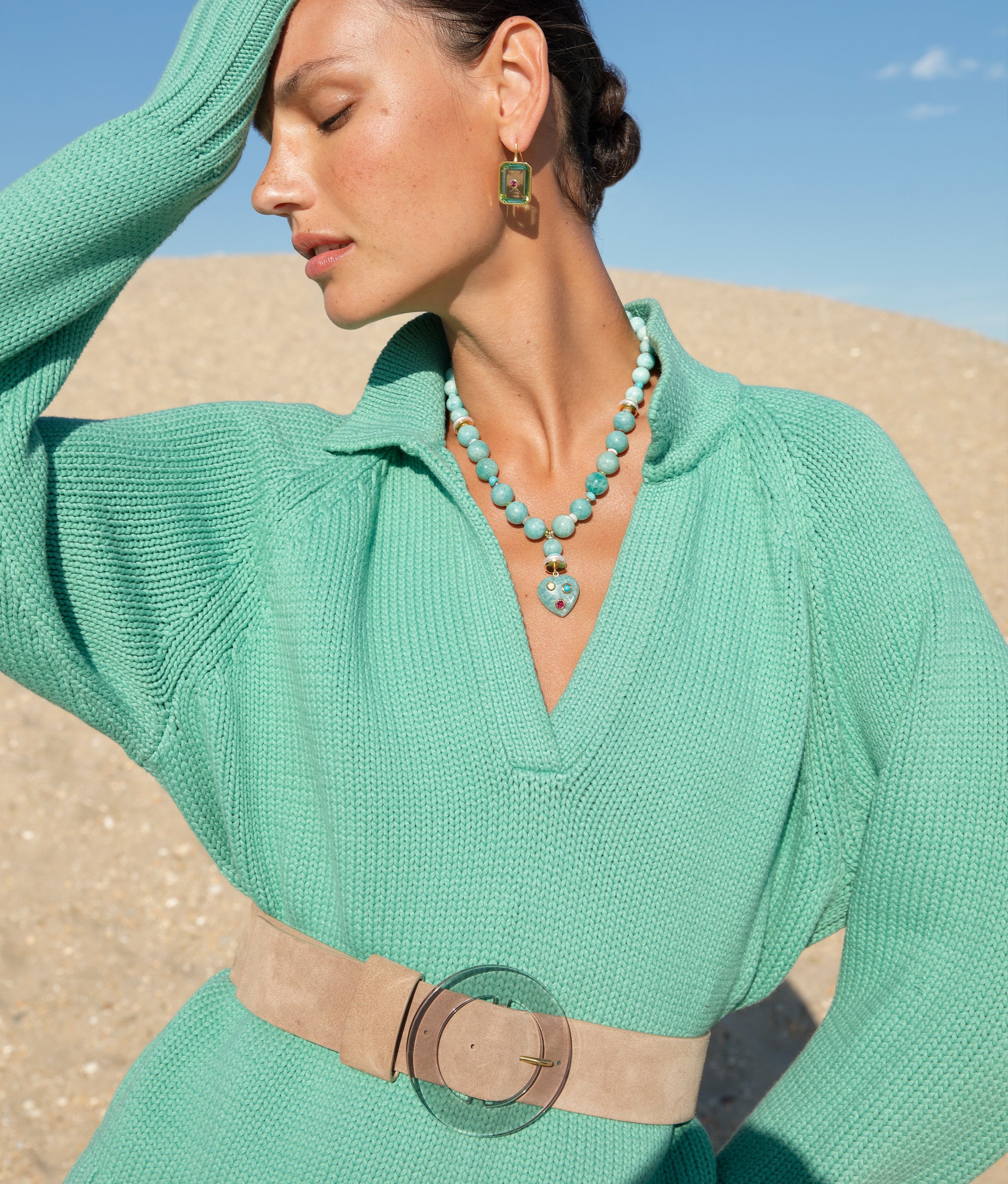Model at the beach wearing the Louise Belt in Light Taupe Suede worn with Tile Earrings in Aqua and Rincon Heart Necklace.