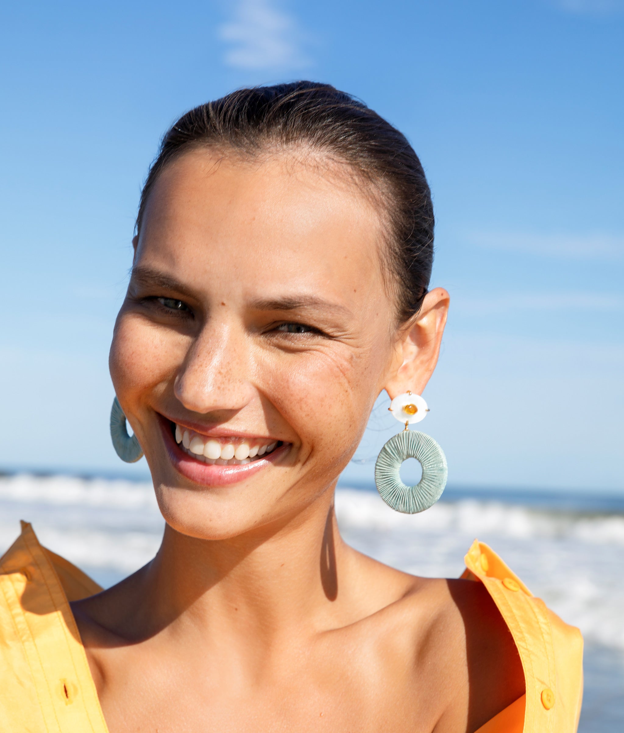 Model at the beach wearing Domingo Earrings.