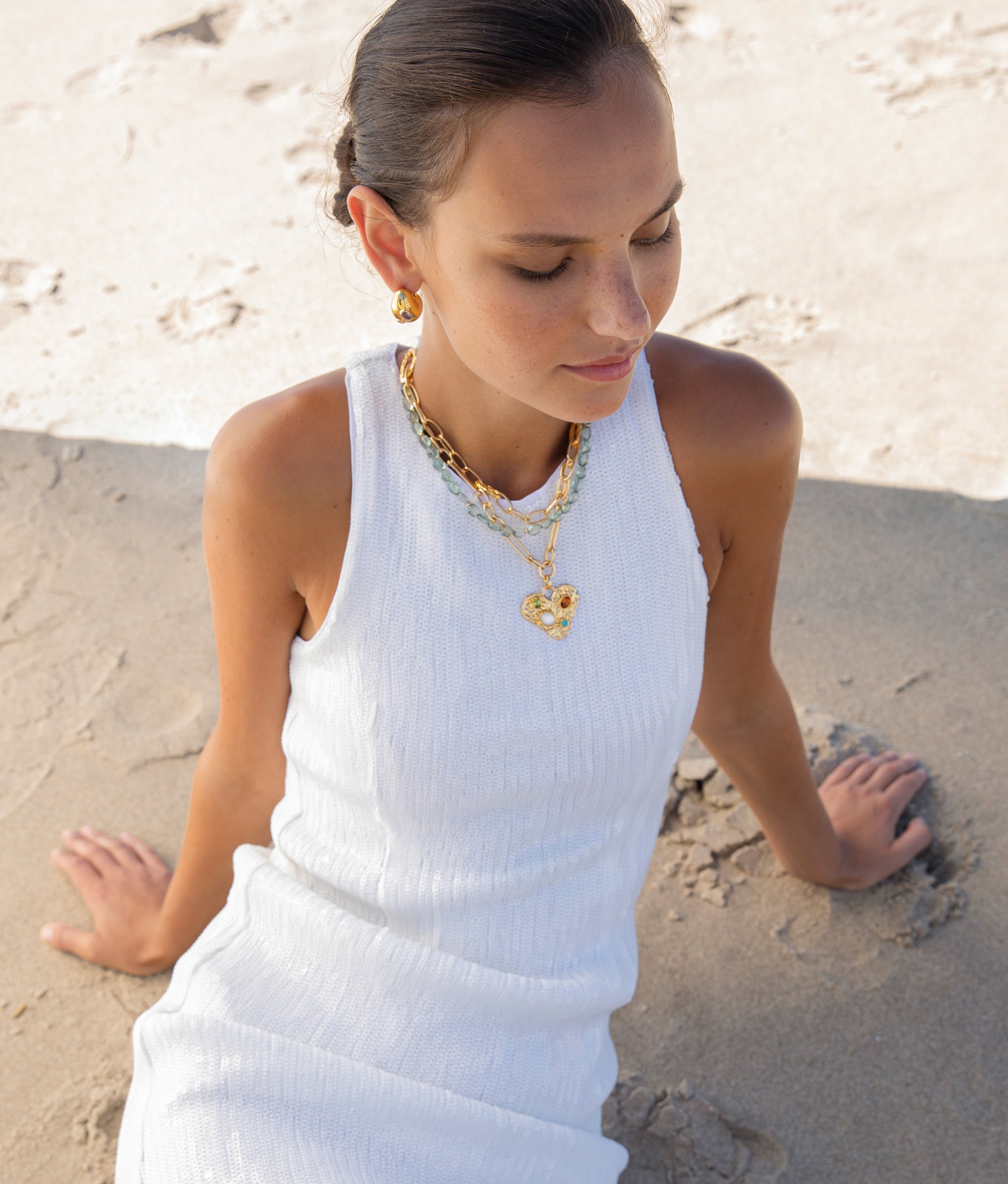 Model on sand background wearing Treasure Trove Necklace.