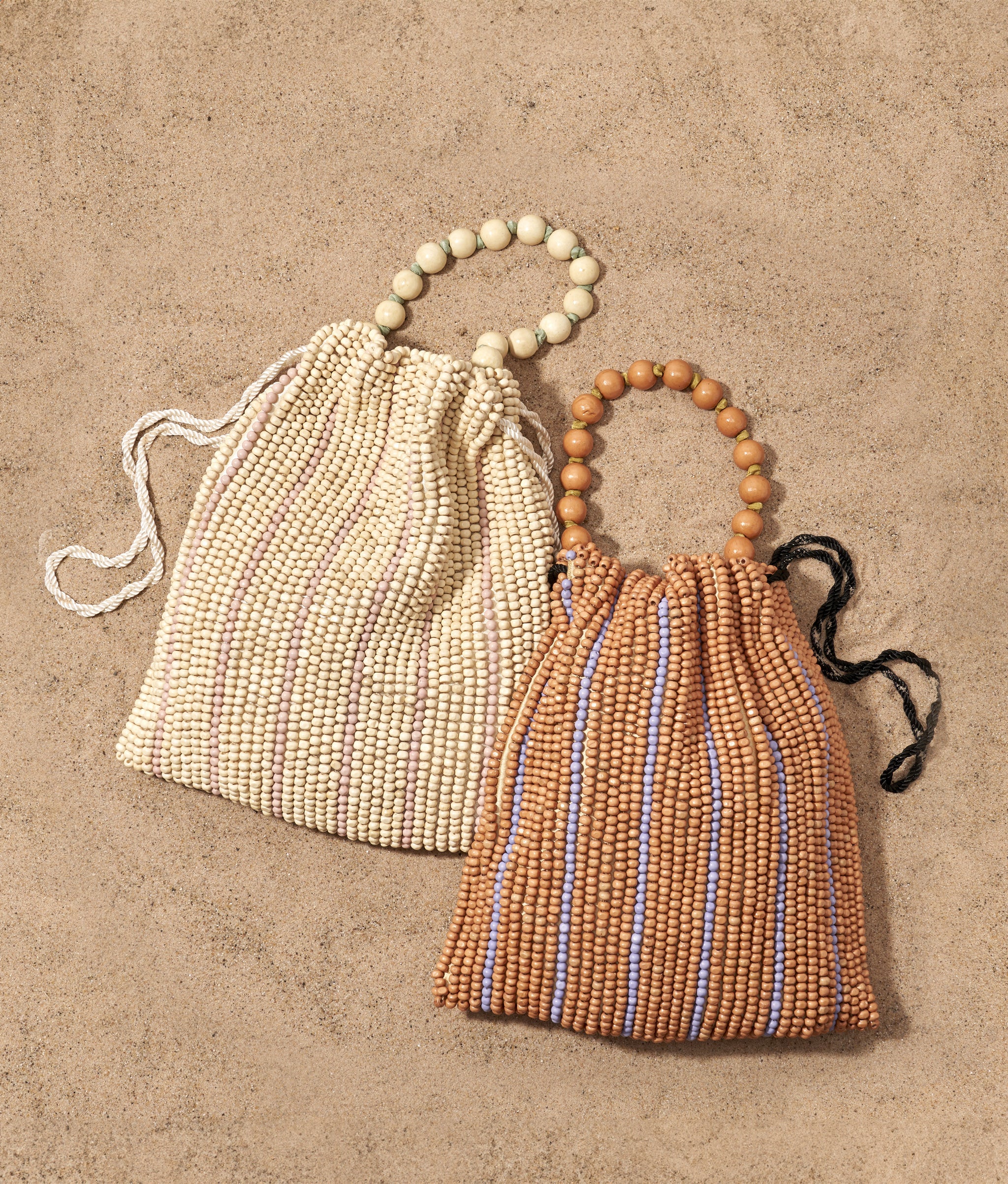 Getaway Bags in Desert Tan and White Heat on a sand background.